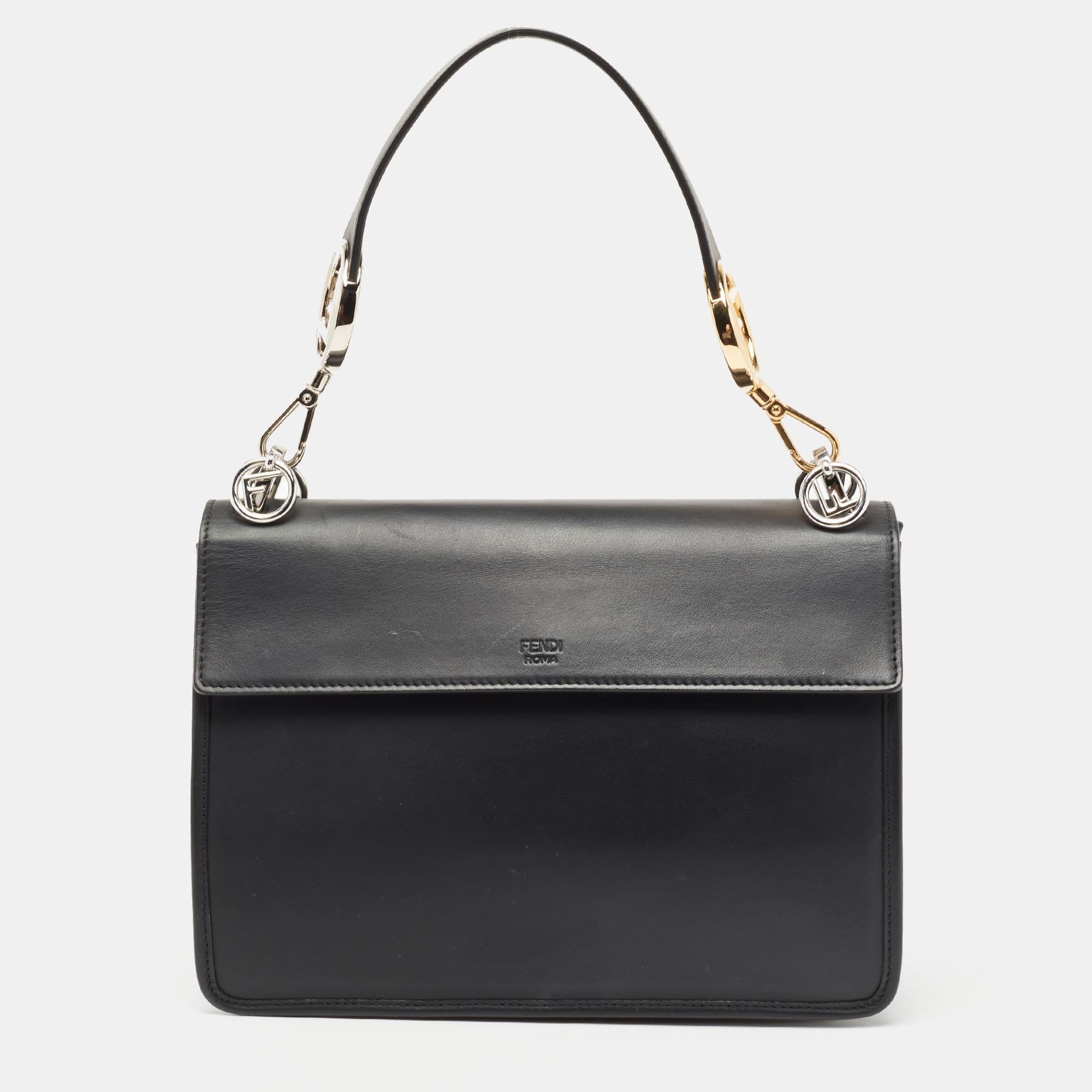 This stunning Kan I bag by Fendi has been crafted to instantly elevate your look. Made of leather in black, this bag has a luxe exterior with the F logo in silver-tone metal on the flap. It can be paraded using the dual carrying options.

Includes:
