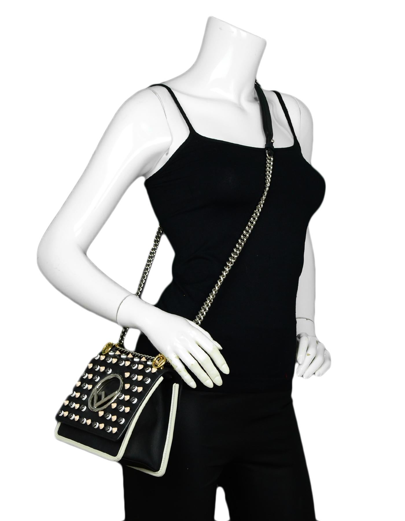 Fendi Black Leather Kan Studded F Logo Flap Crossbody Bag

Made In: Italy
Color: Black
Hardware: Silvertone, Goldtone
Materials: Leather
Lining: Suede
Closure/Opening: Top flap with magnetic snap
Exterior Pockets: None 
Interior Pockets: Flat