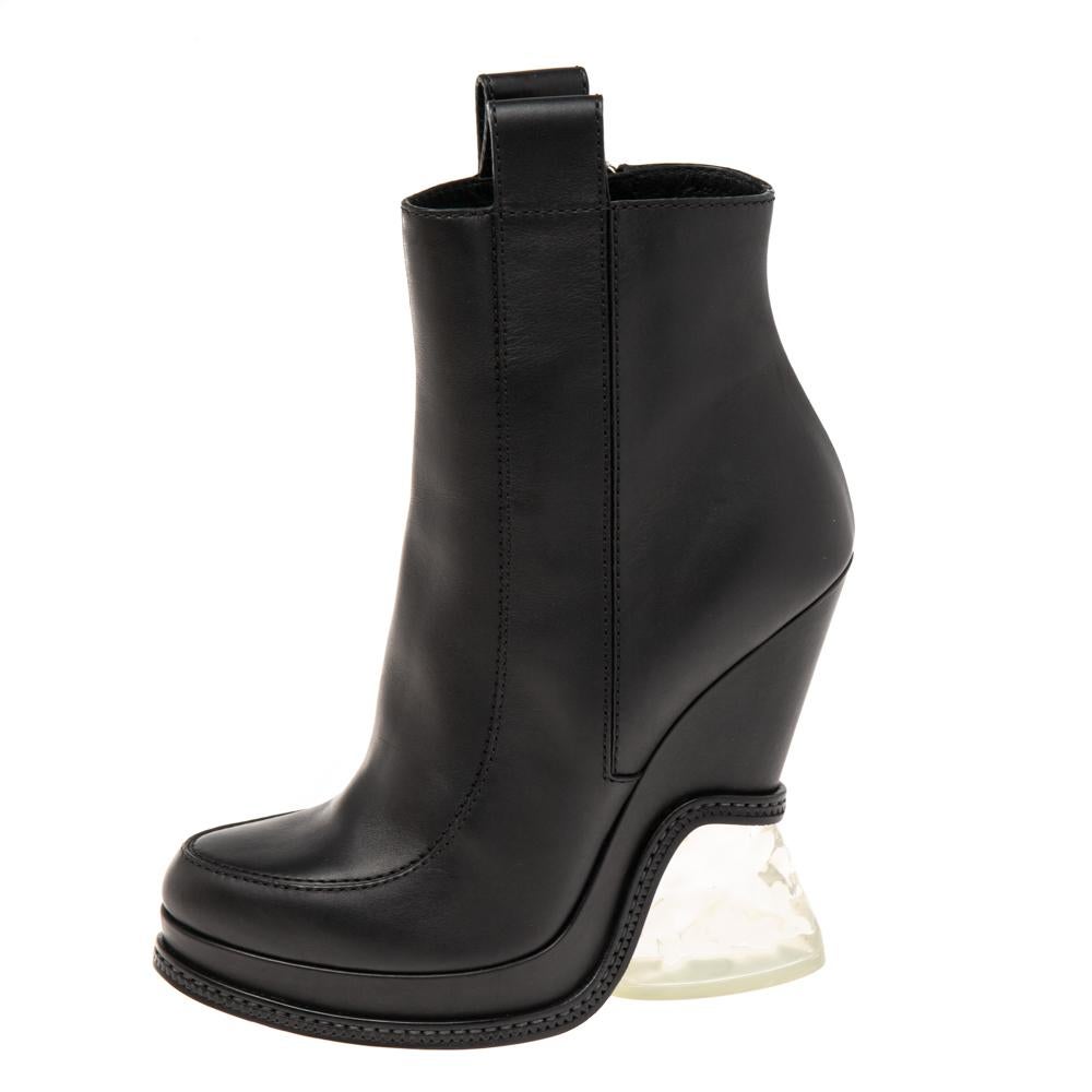 These Fendi black boots with round toes and pull tabs are a high-end fashion item that you need to own now. Transparent lucite heels and neat stitch details on the leather exterior speak glamour. Watch them bring high-octane appeal to your all-black