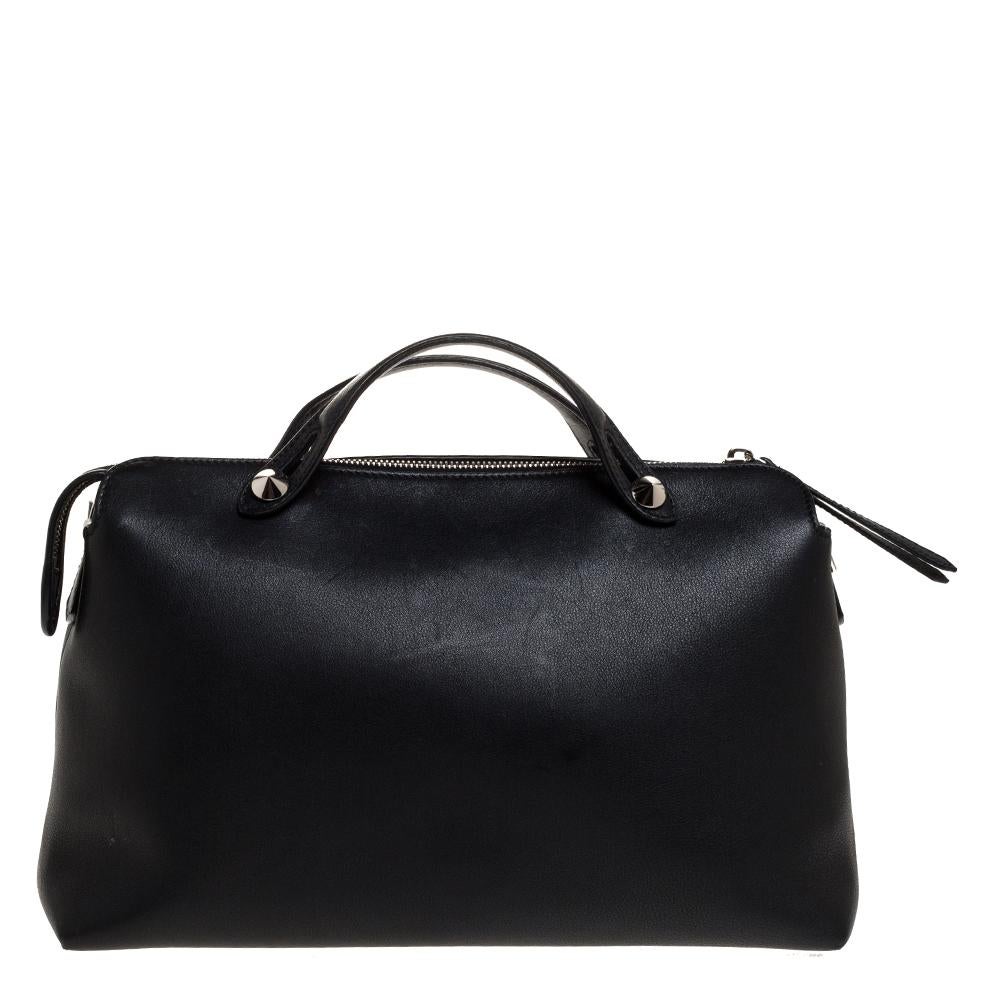 A new design from Fendi, this By The Way Boston bag is made from black leather. Complemented by silver-tone hardware, it has two to handles and a long shoulder strap for crossbody wear. Its main compartment has room for the essentials and is secured