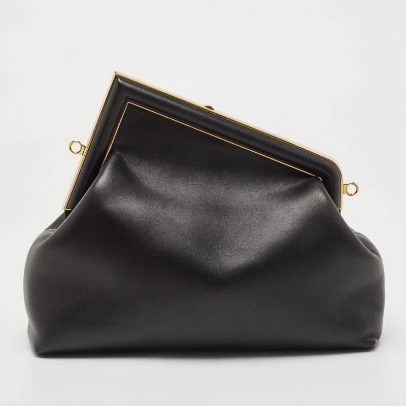 Invite the fashionable charm of the Fendi First clutch into your closet with this piece we have here. It is a small-sized First bag in black leather and gold-tone hardware. The top F logo stands out beautifully, and the shoulder strap provides easy