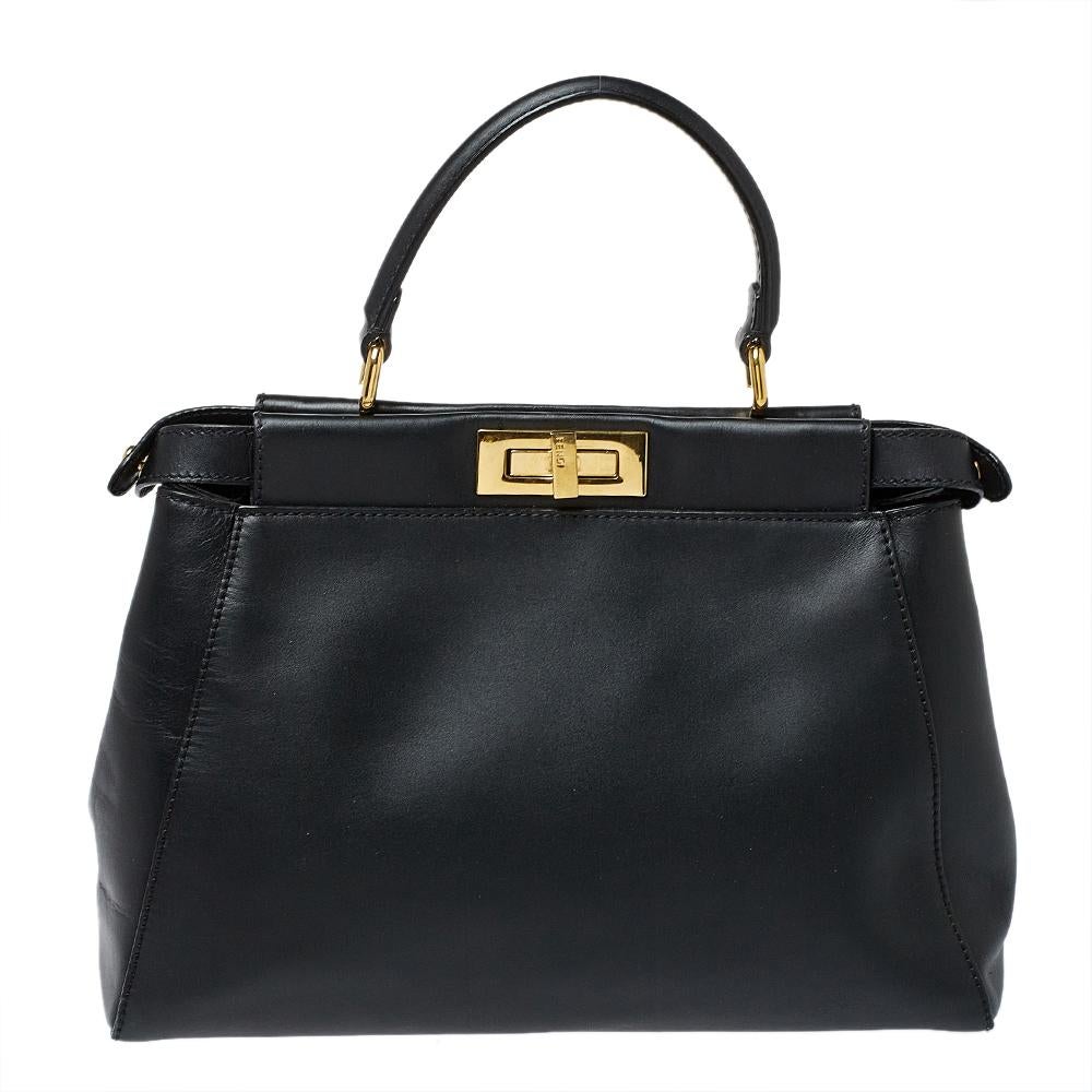 This exquisite Peekaboo from Fendi is highly coveted, and since its birth in 2009, it has swayed us with its shape, design, and beauty. This version comes meticulously crafted from leather and designed with a top handle for you to swing it. A