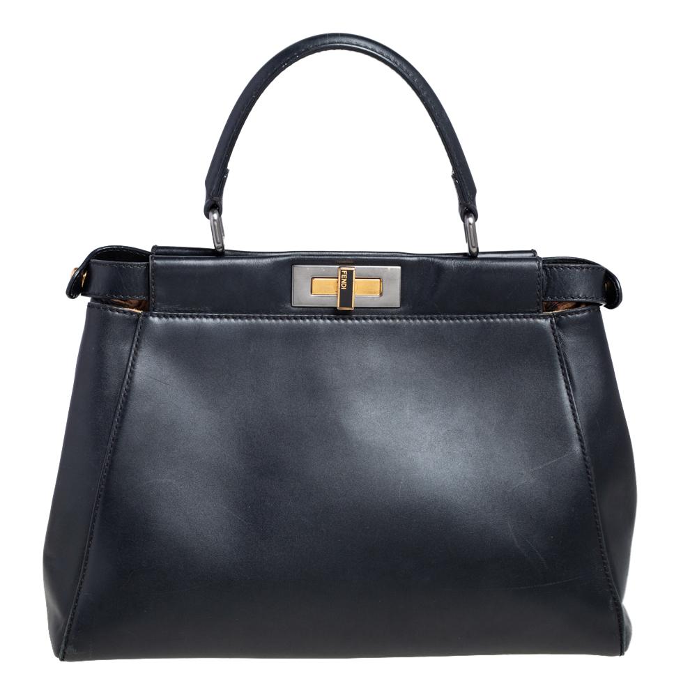 This exquisite Peekaboo from Fendi is highly coveted, and since its birth in 2009, it has swayed us with its shape, design, and beauty. This version comes meticulously crafted from leather and designed with a top handle for you to swing it. A