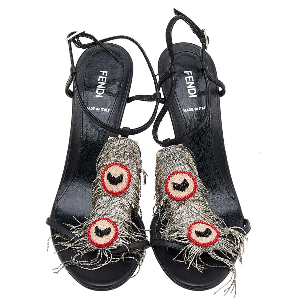These T-strap sandals from Fendi will lend a stylish edge to your feet. They are crafted from black leather and feature metal feather embellishments, open toes, buckle fastening, and 10 cm heels.

