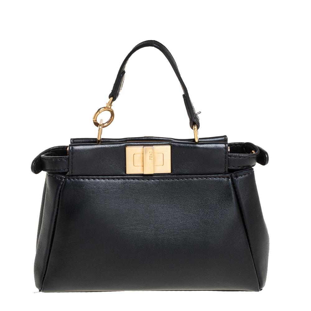 This exquisite Peekaboo from Fendi is highly coveted, and since its birth in 2009, it has swayed us with its shape, design, and beauty. This micro version comes meticulously crafted from leather and designed with a top handle for you to swing it. A