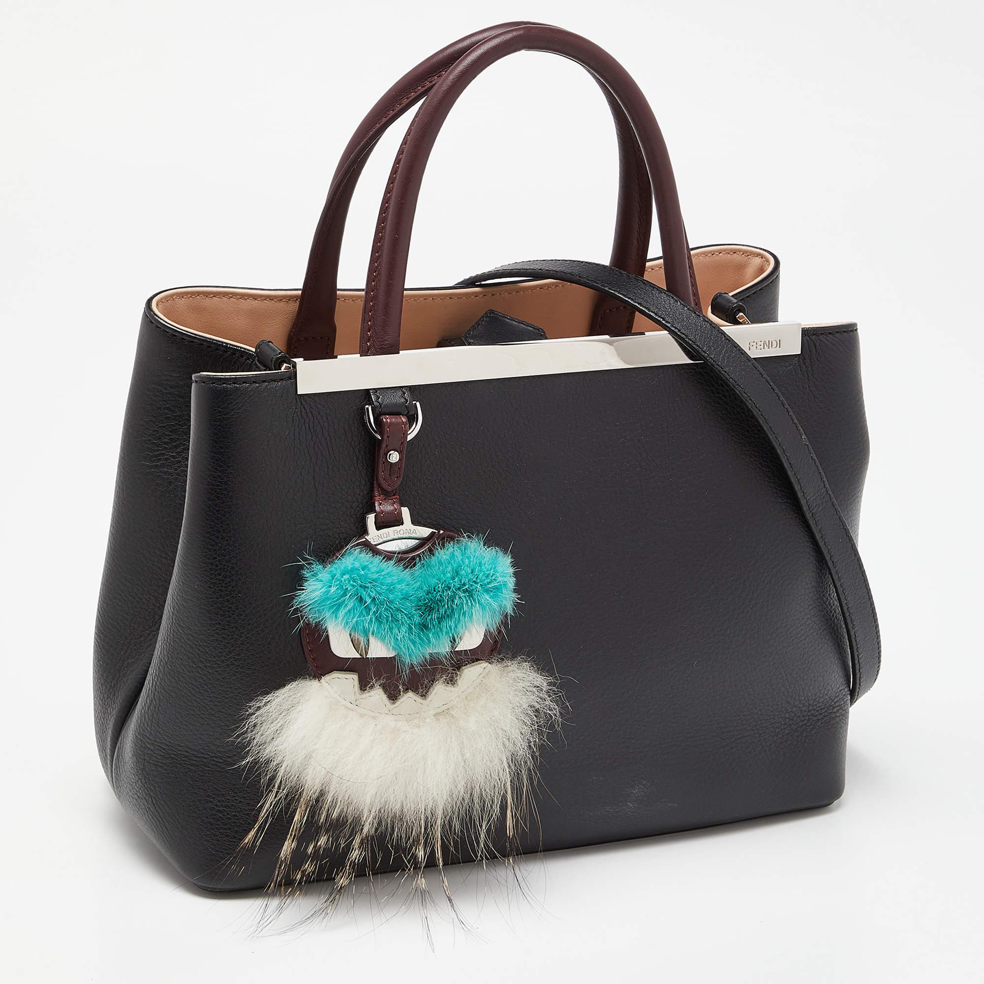 Fendi's 2Jours tote is one of the most iconic designs from the label and continues to gain popularity globally. This version is made from leather and flaunts a monster eye detail at the front. It has silver-toned hardware, dual handles, a shoulder