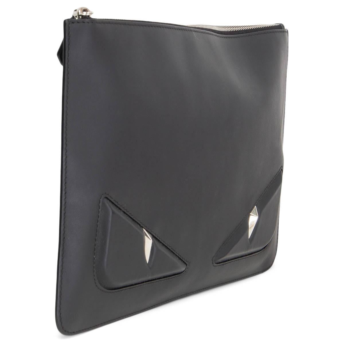 100% authentic Fendi Monster flat clutch in black leather. It features a top zip-up closure that reveals a fabric-lined interior and brand labelling. It is accented with silver-tone hardware. Has been carried and is in excellent condition. Comes