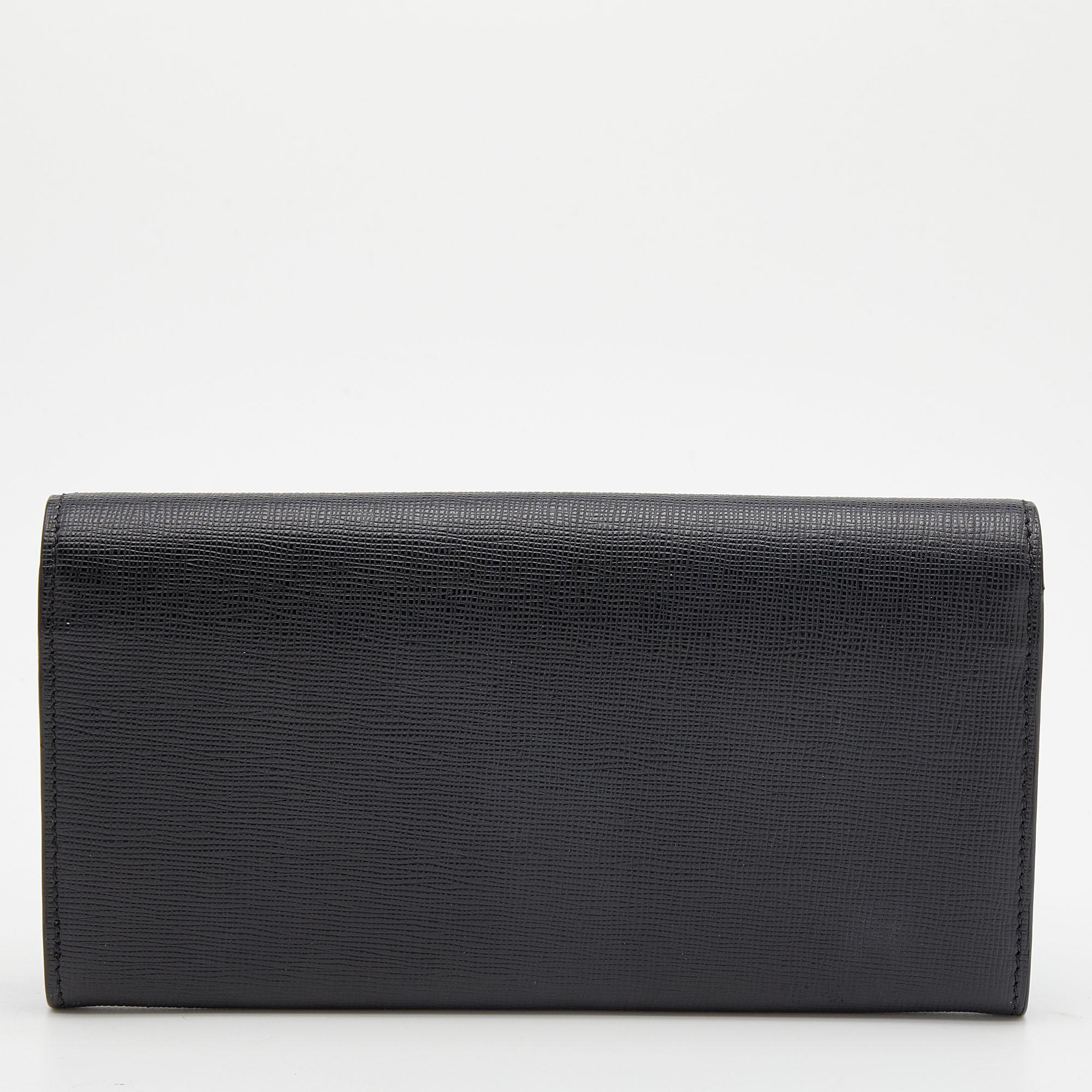 Made of black leather, this continental wallet from Fendi is a classy choice. The flap is adorned with 'Monster Eyes' and it opens to multiple card slots and a zipped pocket.

