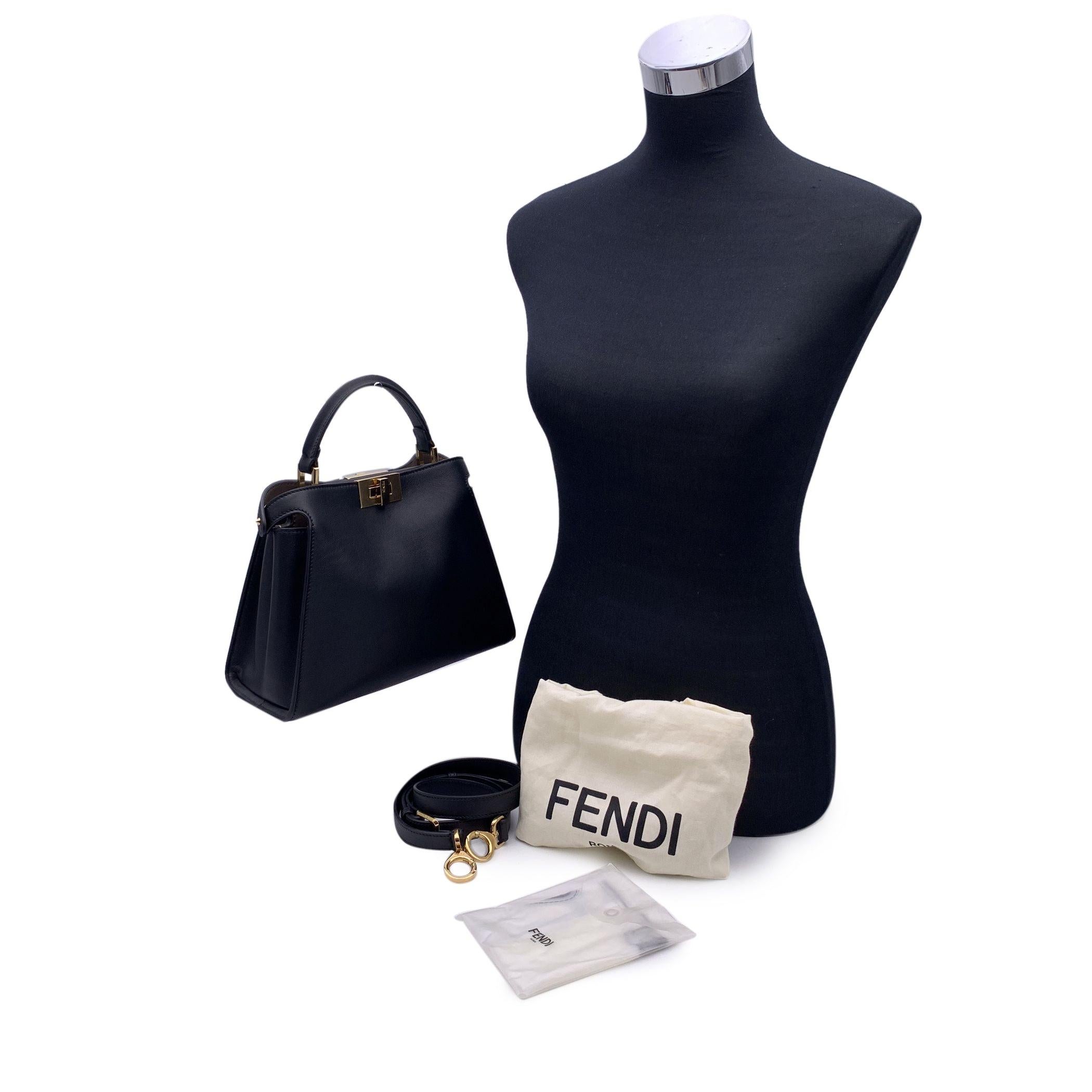 This beautiful Bag will come with a Certificate of Authenticity provided by Entrupy. The certificate will be provided at no further cost. Introducing the Fendi Mini Peekaboo Iconic Essentially Bag in luxurious black leather - a perfect balance of
