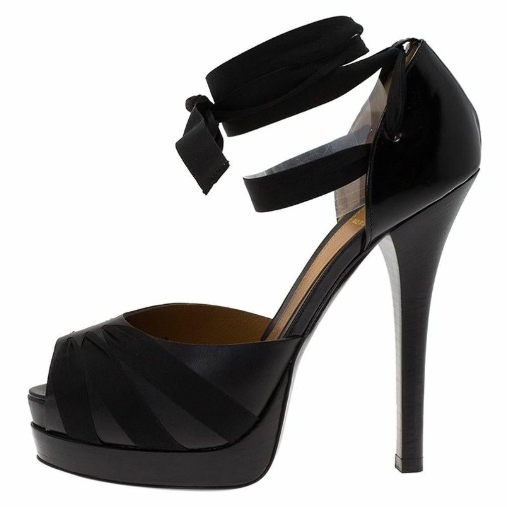 These black Fendi stiletto pumps are an ode to elegance. The island platform sole with open toe, comfortable vamps, counter and the ankle strap help secure the shoes. The added detail of a bow around the ankle adds to the ballerina look of the