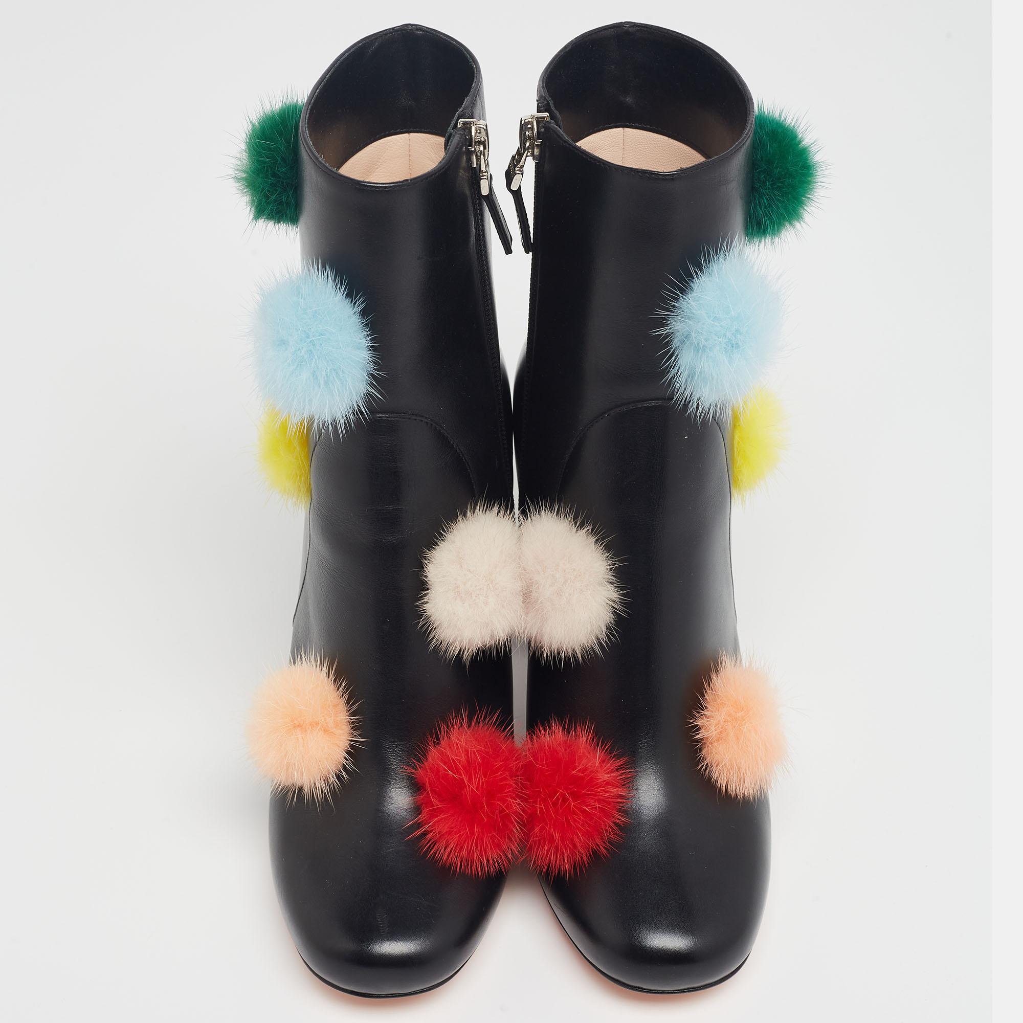 These stylish ankle booties from Fendi are absolute closet essentials. Crafted from quality leather in Italy, they come styled with rounded toes, playful pom-pom detailing, zip closures, and block heels. They are endowed with comfortable leather