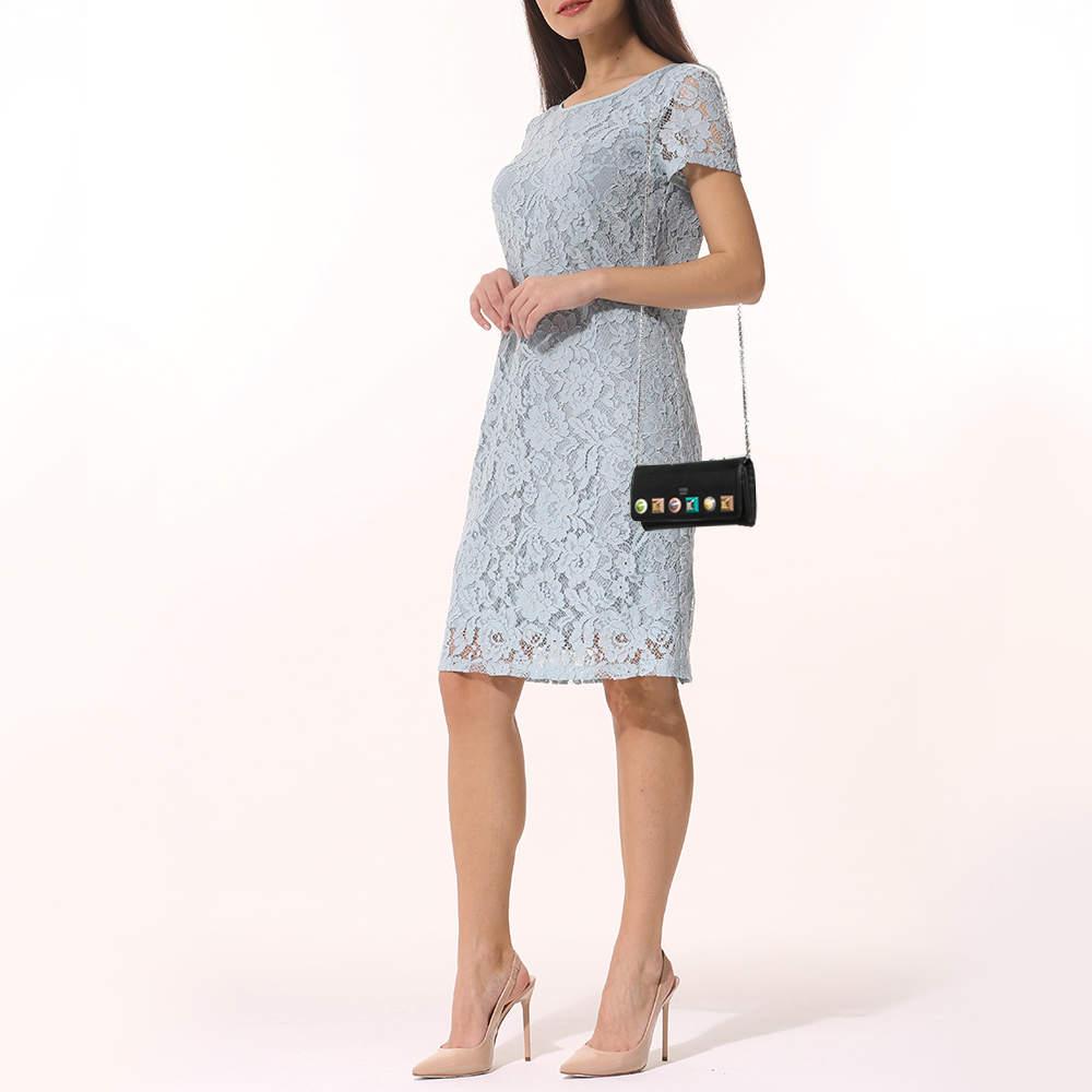 Unique trendy and chic this Fendi WOC is a stylish piece to add to your collection. It has been crafted from leather in a black shade and decorated with exaggerated studs on the front flap that opens to multiple compartments for your monetary