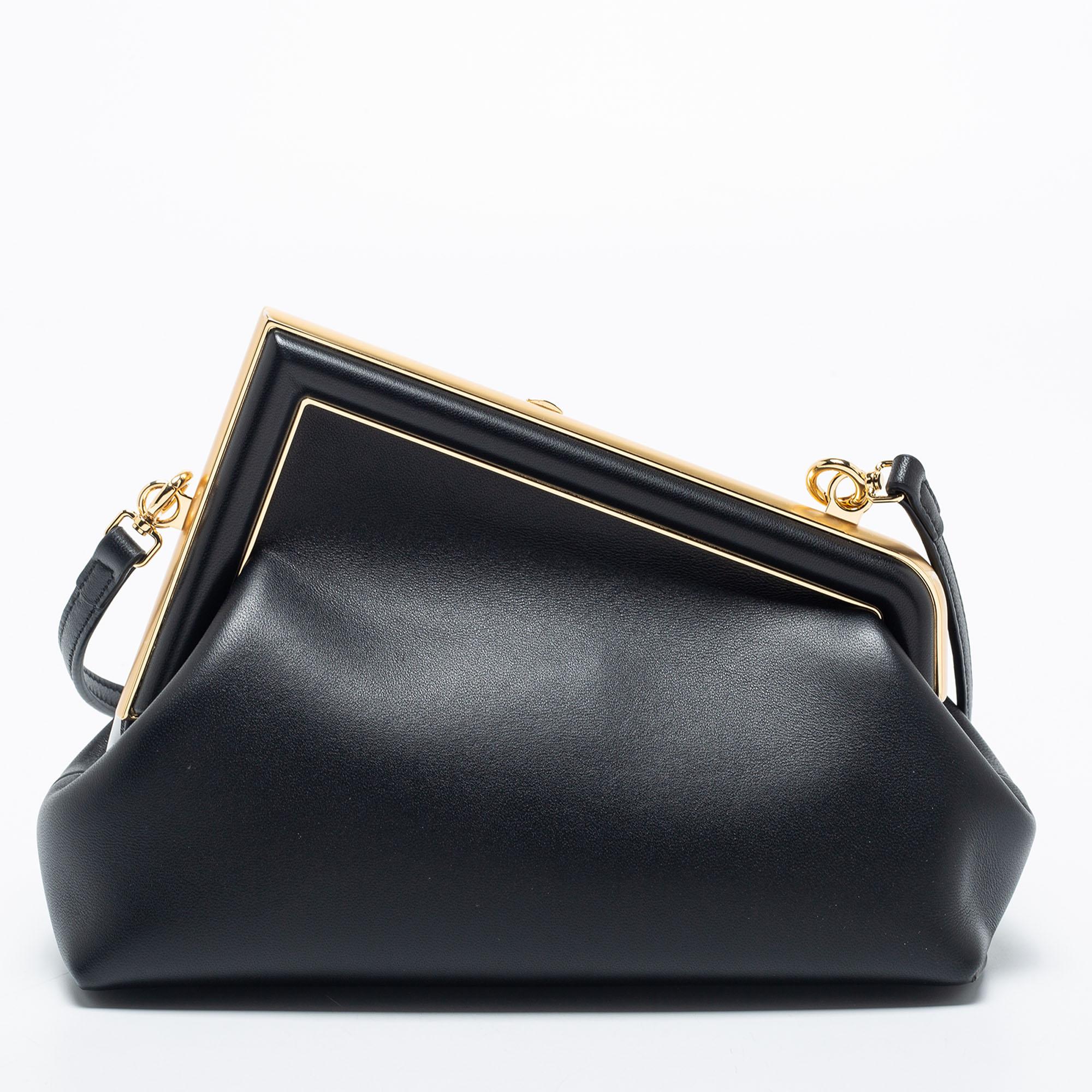 Feel stylish every time you walk out with this skillfully made, iconic Fendi shoulder bag. Crafted from black leather, the Fendi First bag features an uber-chic F-shaped frame top. Lined with smooth canvas on the inside, it is made to keep your