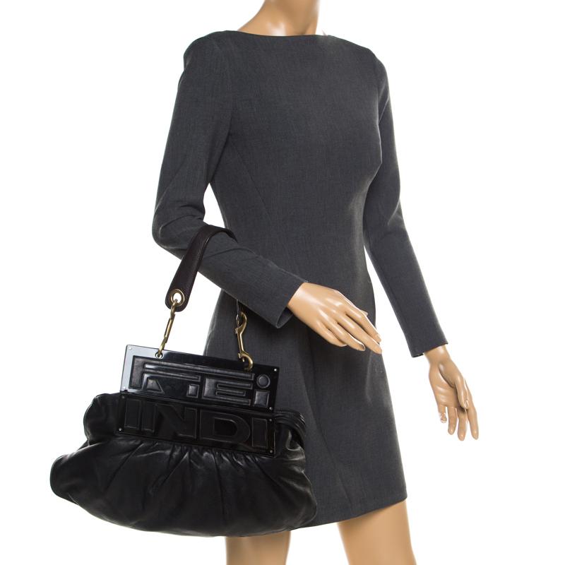 This Fendi bag is truly a work of art. The To You has been a favorite among celebrities and it's easy to see why with its gorgeous black leather and acrylic panels that fold over to convert into a giant clutch! With a single handle, the interior has