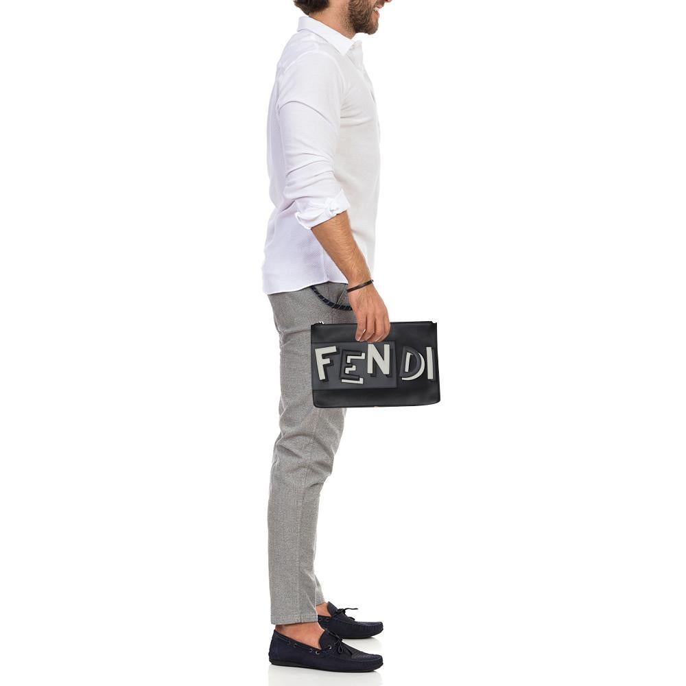 This men's pouch from Fendi has been made using quality leather in Italy. It has a fabric-lined interior that is secured by a top zip closure. This black pouch has a simple shape and 3D brand name on the front.

Includes: Original Dustbag, Original