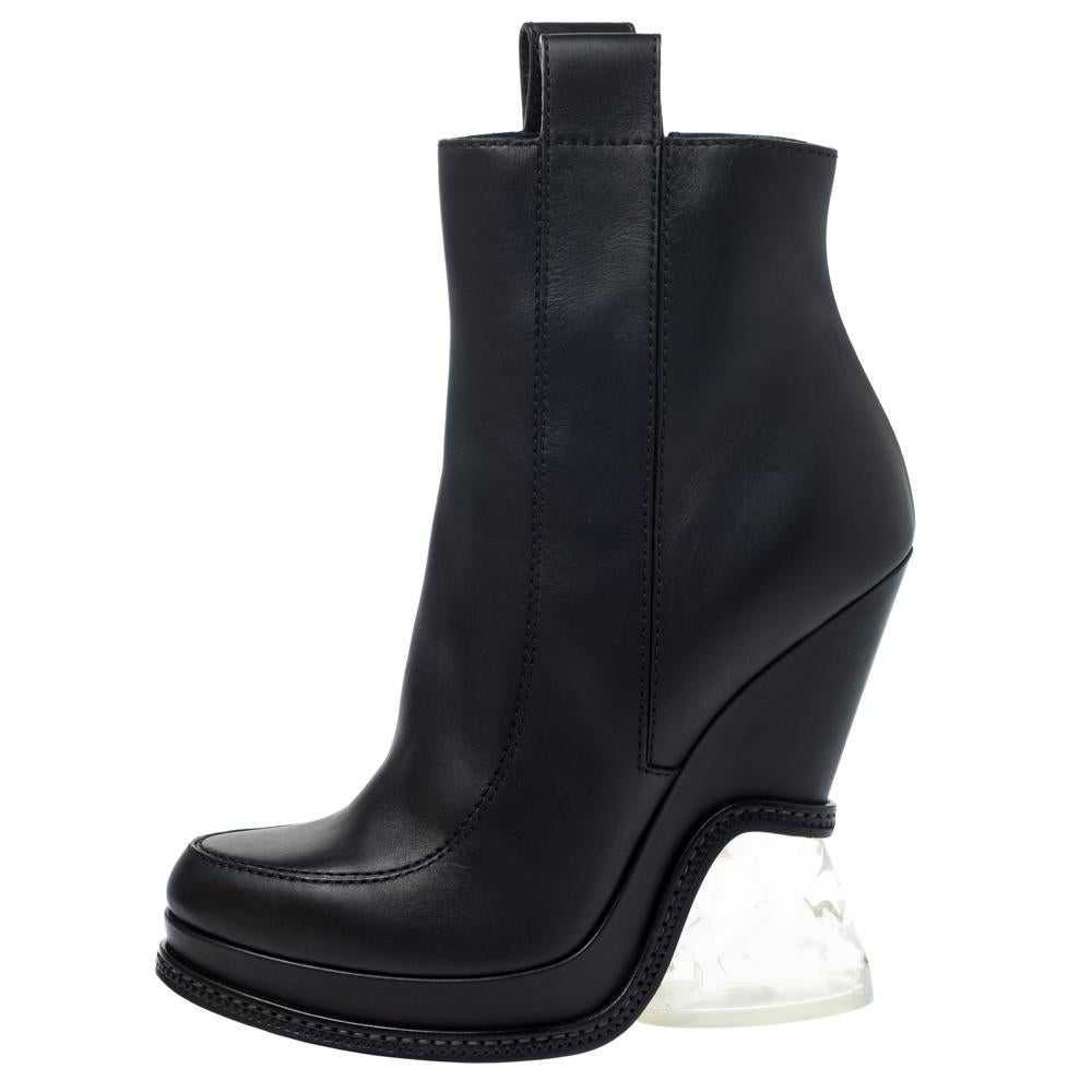 These Fendi boots with round toes and pull tabs are an high-end fashion item that you need to own now. Block transparent lucite heels and neat stitch details on the exterior speak statement. Watch them bring high-octane appeal to all-black evening