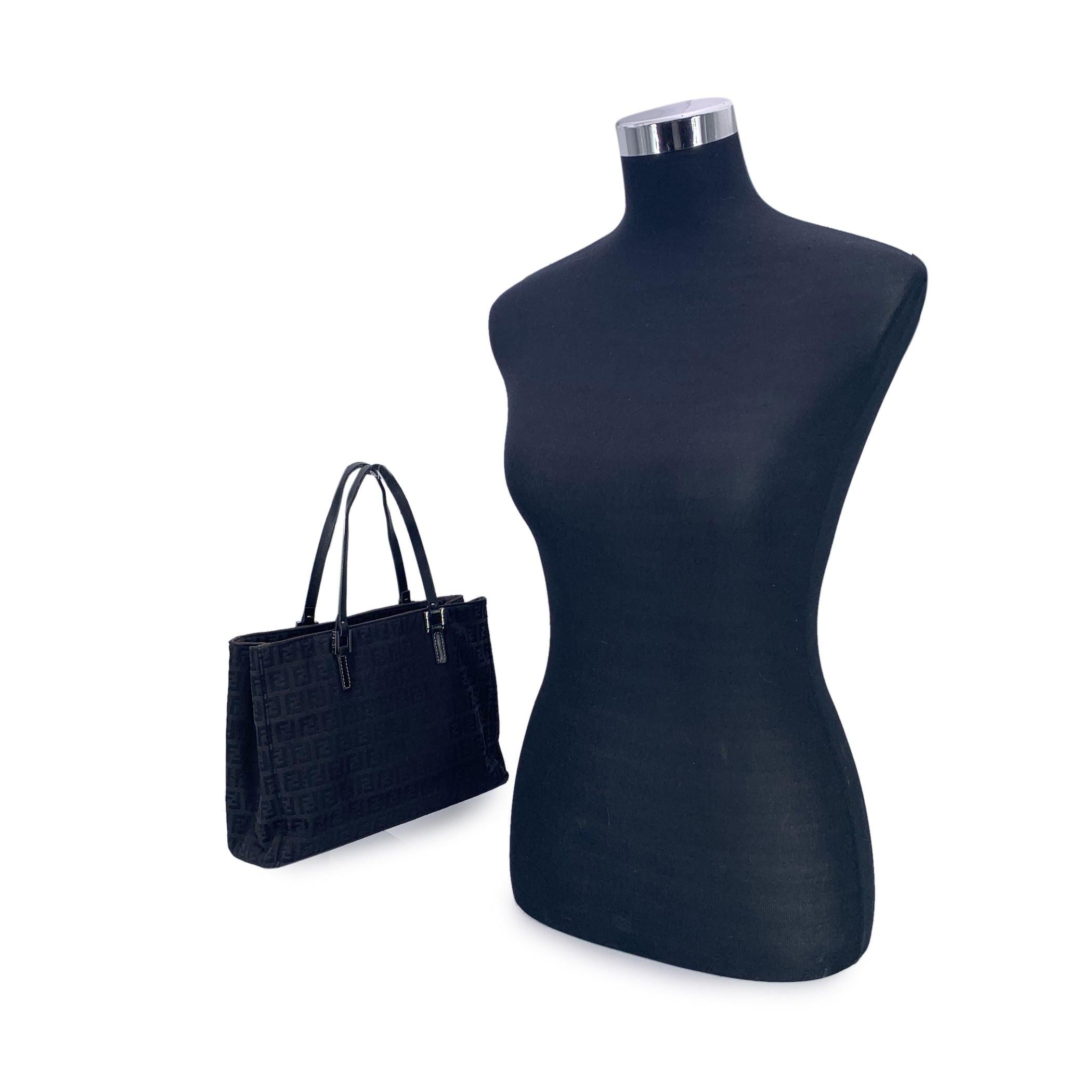 Step into the world of timeless Italian design with this beautiful Fendi tote bag, crafted in the iconic black Zucchino monogram canvas. A refined everyday companion, it features sleek black leather trim and matching handles that add structure and