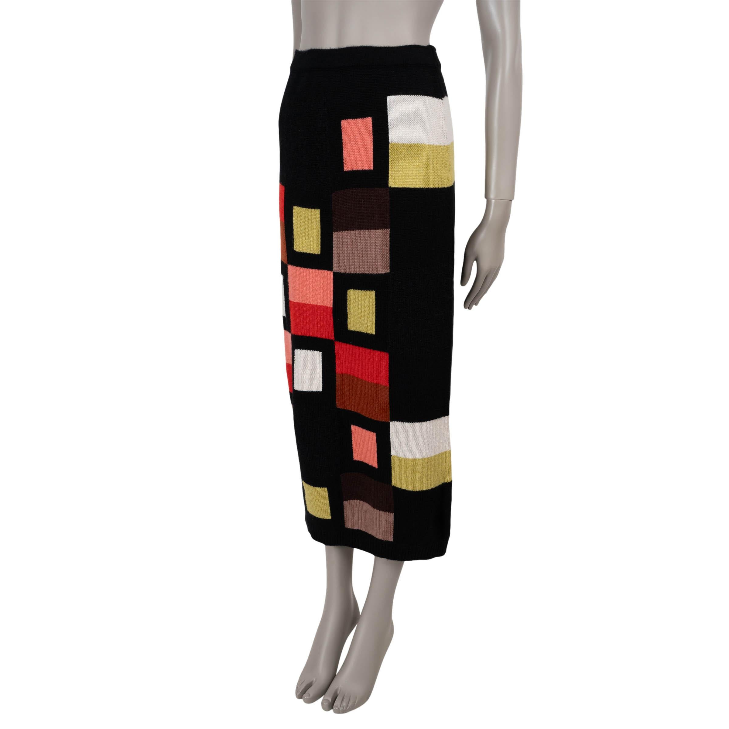 This 100% authentic Fendi knit skirt in black wool-blend (please note the content and size tag are missing) is elevated with a multicolored geometric pattern, blending modern design with classic elegance. Featuring a fitted silhouette with a midi