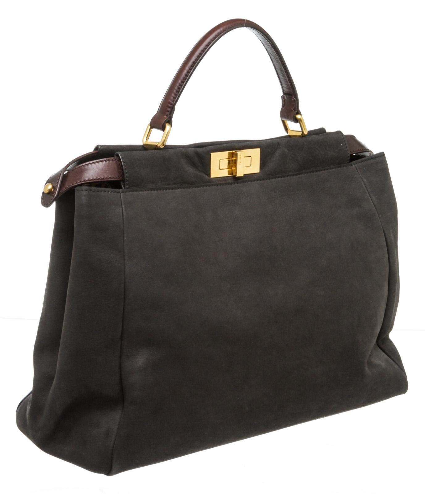 Fendi black nubuck Large Peekaboo satchel with gold-tone hardware, dual interior compartments with logo turn-lock closure, interior pocket with zip top, brown leather top handle.

16135MSC