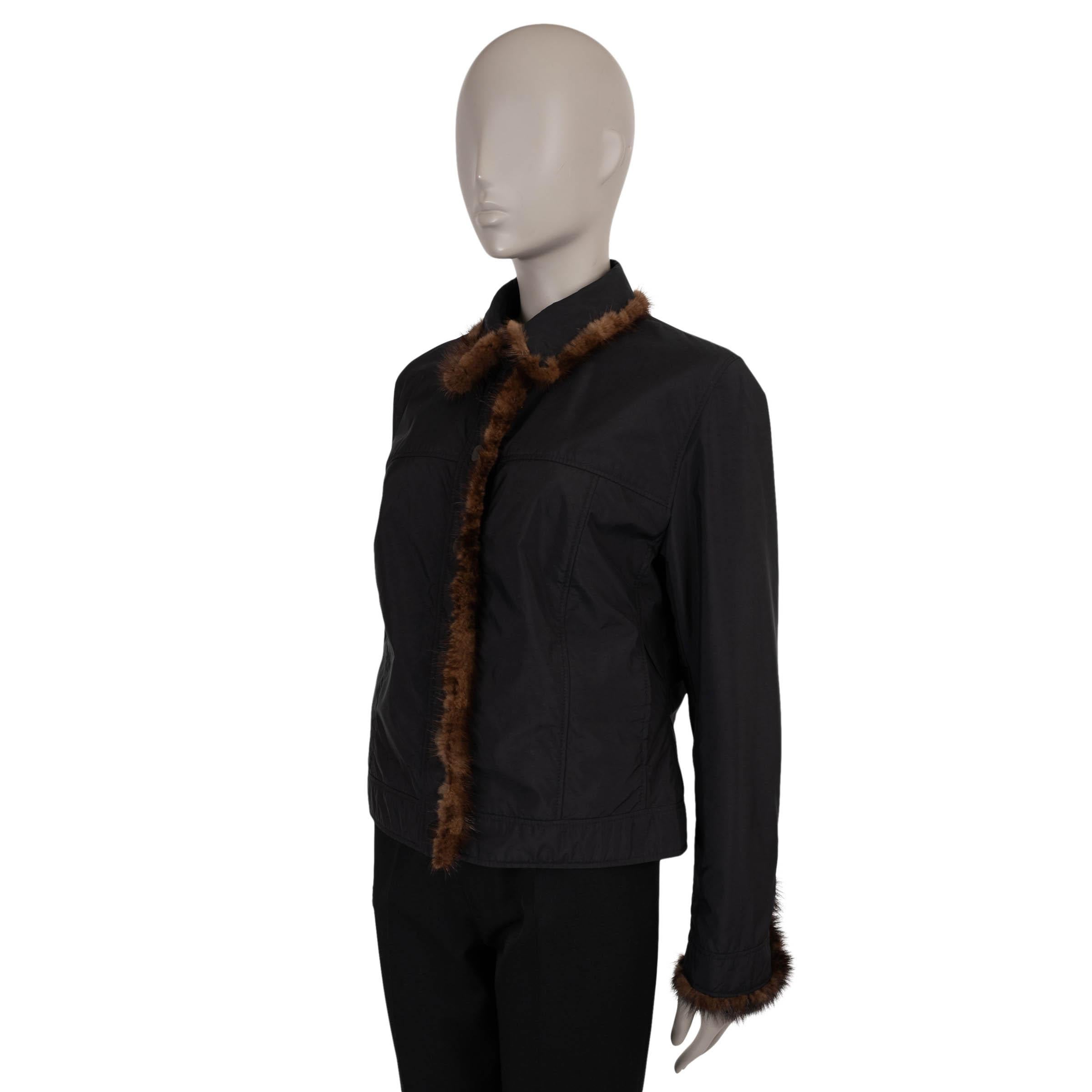 This 100% authentic Fendi windbreaker in black nylon (100%) is a luxurious take on a sporty essential. Featuring a fitted, short silhouette, it is elevated with a rich brown mink fur trim. Designed with two slant pockets for practicality, it closes