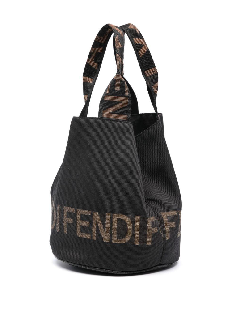 2000s Fendi black ottoman bucket bag featuring black
cotton gabardine weave, two logo-print handles, bucket body, a jacquard Fendi motif, an internal logo plaque and a concealed press-stud fastening.
Length 7.1in (18cm)
Height 11.8in. (30 cm)
Depth