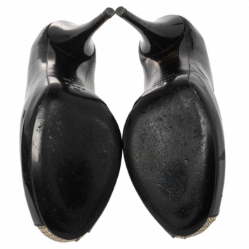 Visually stunning and classic, these pumps from Fendi are a closet staple. They are crafted from black patent leather and styled with gold leather trims. They feature a peep-toe silhouette with gold-tone logo accents on the vamps, 13 cm high heels,