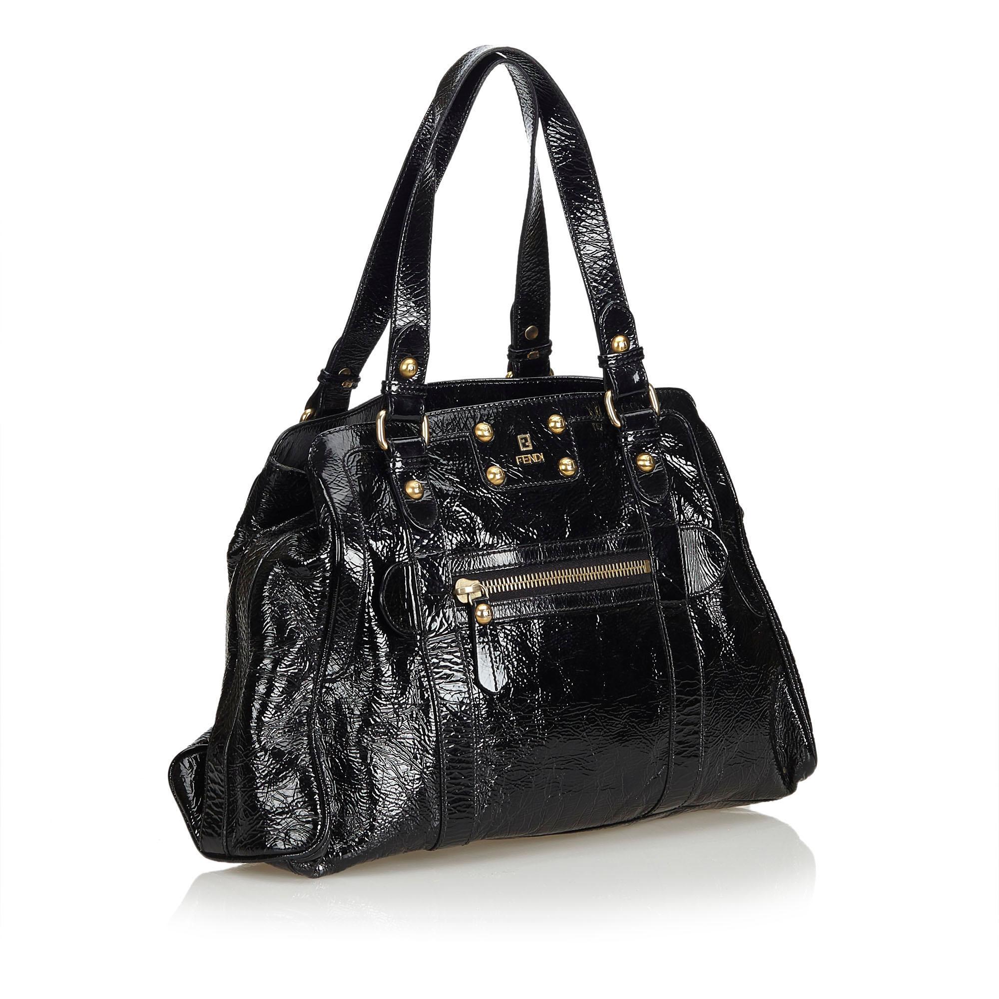 The Du Jour Tote features a patent leather body, front exterior zip pocket, flat leather handles, an open top, and interior zip pocket. It carries as B condition rating.

Inclusions: 
This item does not come with inclusions.

Dimensions:
Length: