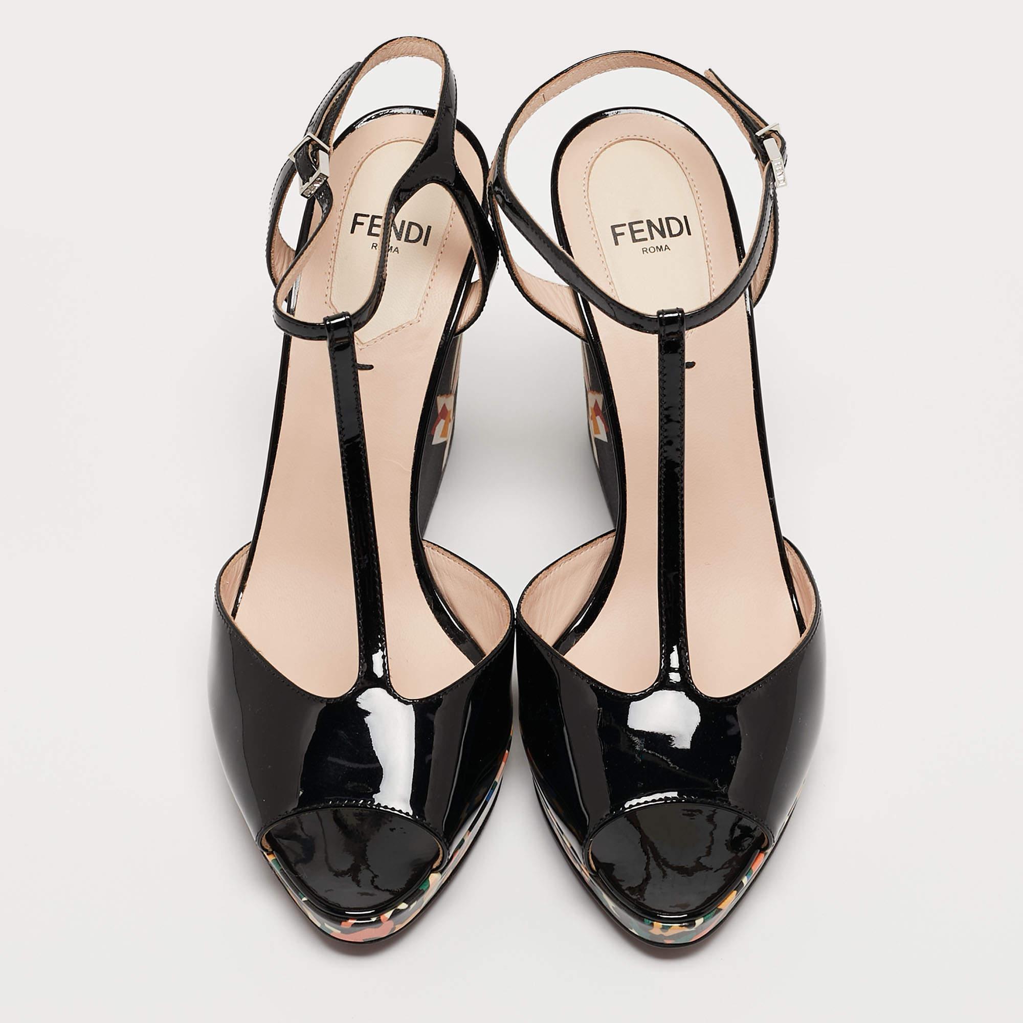 You won't be able to resist this pair of flawless Fendi sandals. Made from patent leather, the sandals feature peep toes, a T-strap, and adjustable ankle strap fastening. Their wedge heels feature Bird of Paradise motifs.

Includes: Original