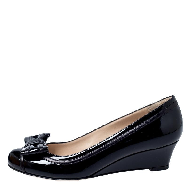 Walk with style and comfort in these pumps from Fendi. Crafted from leather in Italy, these black shoes carry round toes, wedge heels and bow detailing. They are complete with the brand label on the insoles and outsoles.

Includes: Original Box,