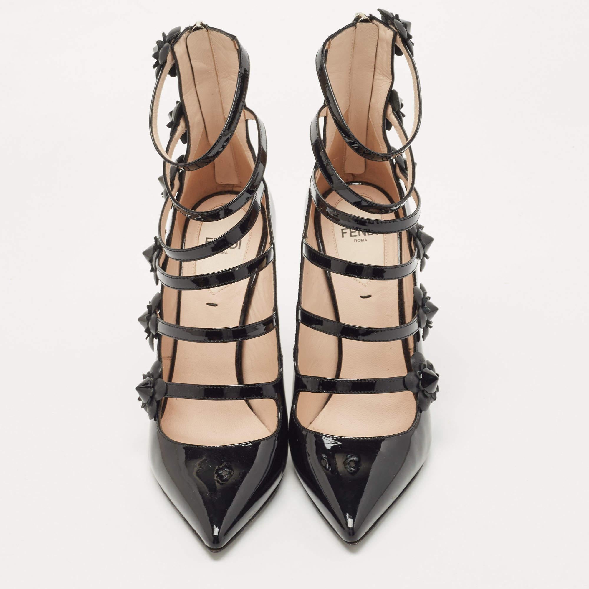 These black pumps from Fendi have been crafted from patent leather into a pointed-toe silhouette, styled with straps and floral studs. They come equipped with back zippers and stiletto heels.

Includes: Original Dustbag, Original Box

