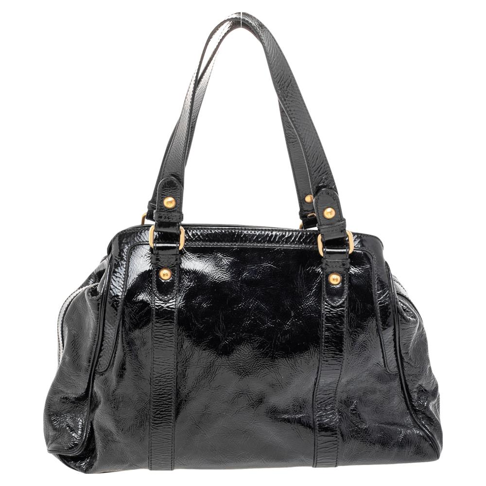 This de Jour tote from Fendi has a sophisticated look. Crafted from black patent leather, the exterior features double top handles and a front zip pocket. The canvas-lined interior has enough space to hold all your daily necessities. Team this