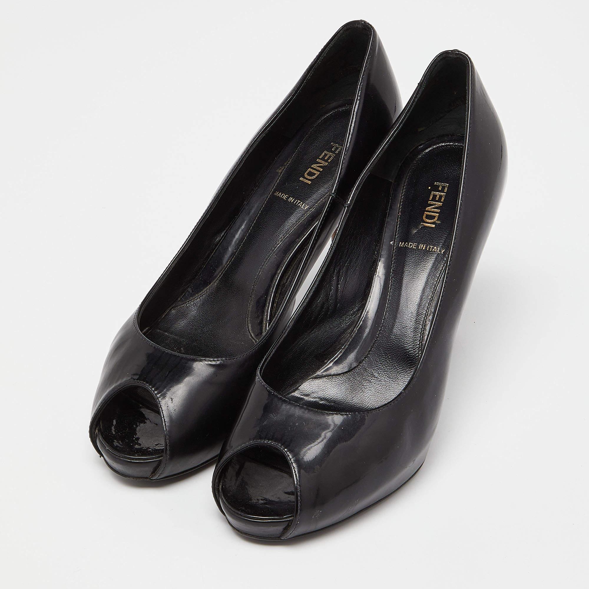 Look classy in this pair of pumps designed by Fendi. Made from black patent leather they have sophisticated 10cm heels covered in the signature motif. These platform pumps feature peep toes and the insoles are lined with leather.