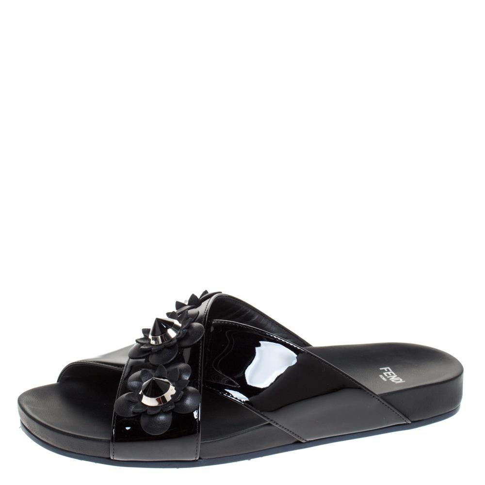These designer flats from the house of Fendi are a must-have in your wardrobe. They feature patent leather cross straps embellished with flowers and studs. Team up these rubber-soled flats with a pair of jeans and a cotton top for a casual