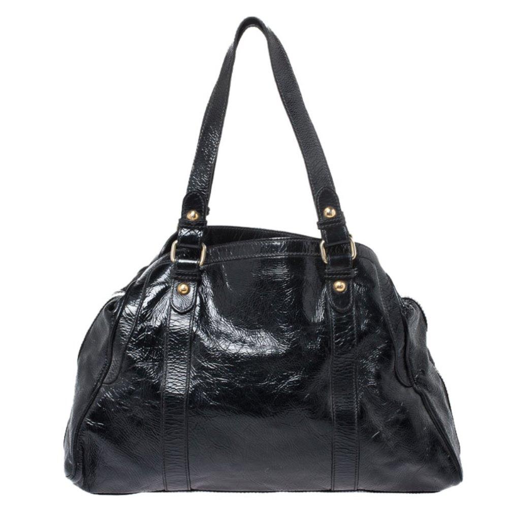 Keep it classy with this stunning Fendi satchel. Crafted from quality patent leather, it comes in a classic shade of black. The bag held by dual handles and features an exterior zip pocket. It comes with hook closure, a spacious fabric-lined