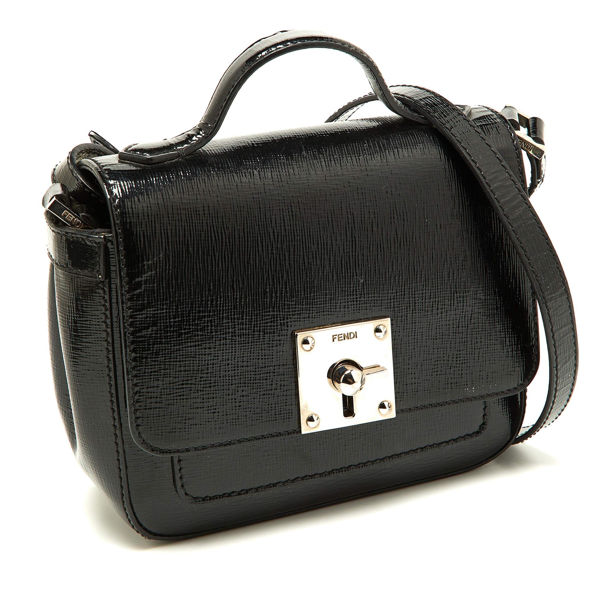 Chic and classy, this Fendi patent leather mini cross-body bag will surely be your new go-to bag. It features a luxurious exterior on it's structured shape and an adjustable shoulder strap. It also has a top handle and a silver-tone turn-lock