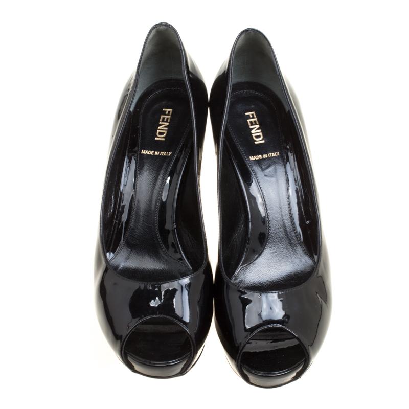 Bold, stylish and very classy, these pumps from Fendi will fetch you admiring glances for every step you take! The black pumps are crafted from patent leather and feature a peep-toe silhouette. They flaunt comfortable leather lined insoles, 9.5 cm