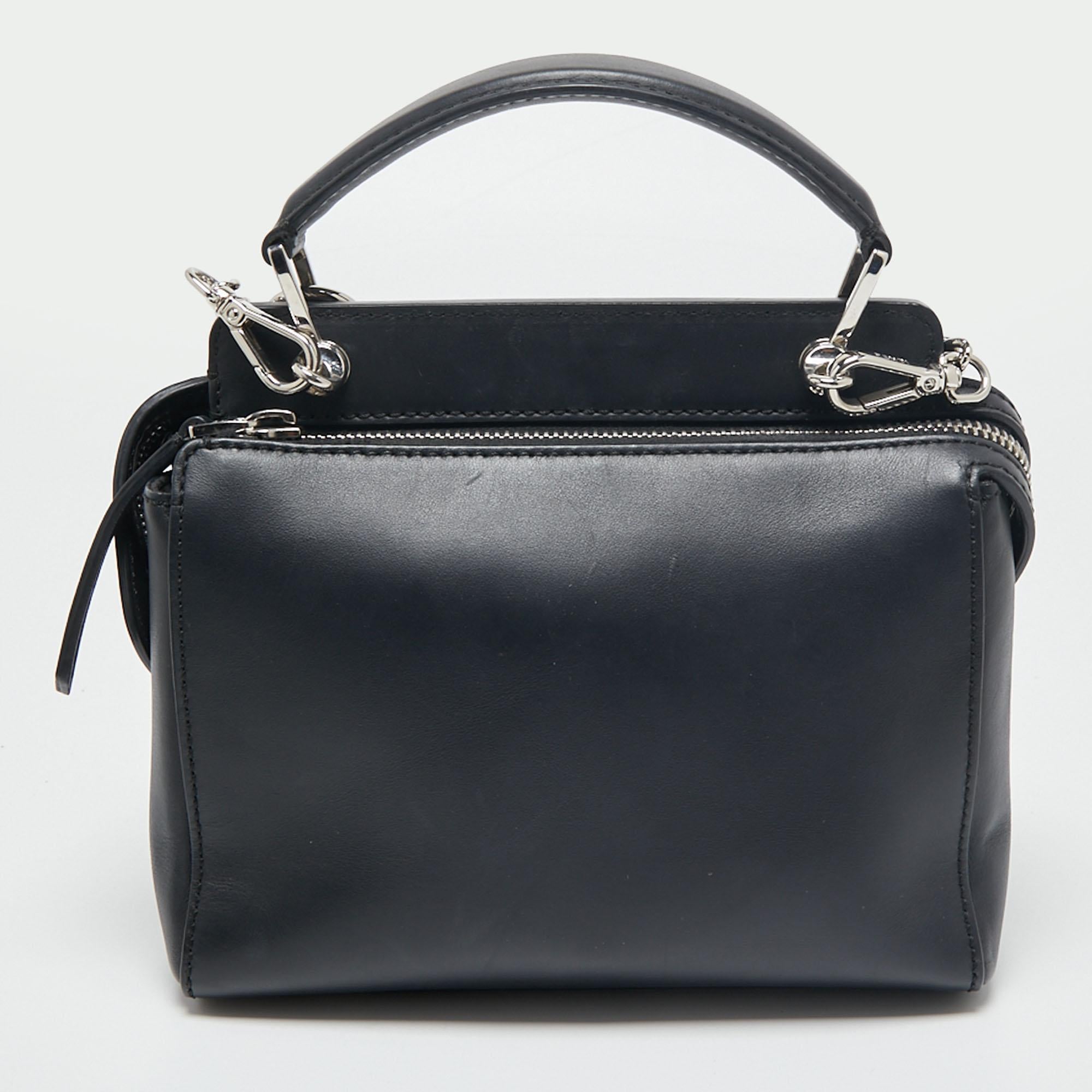 We are in love with this shoulder bag from Fendi. Skilfully crafted from leather, it has a decorated exterior, and the top zippers reveal suede compartments roomy enough to carry your daily essentials. The black bag is complete with protective metal