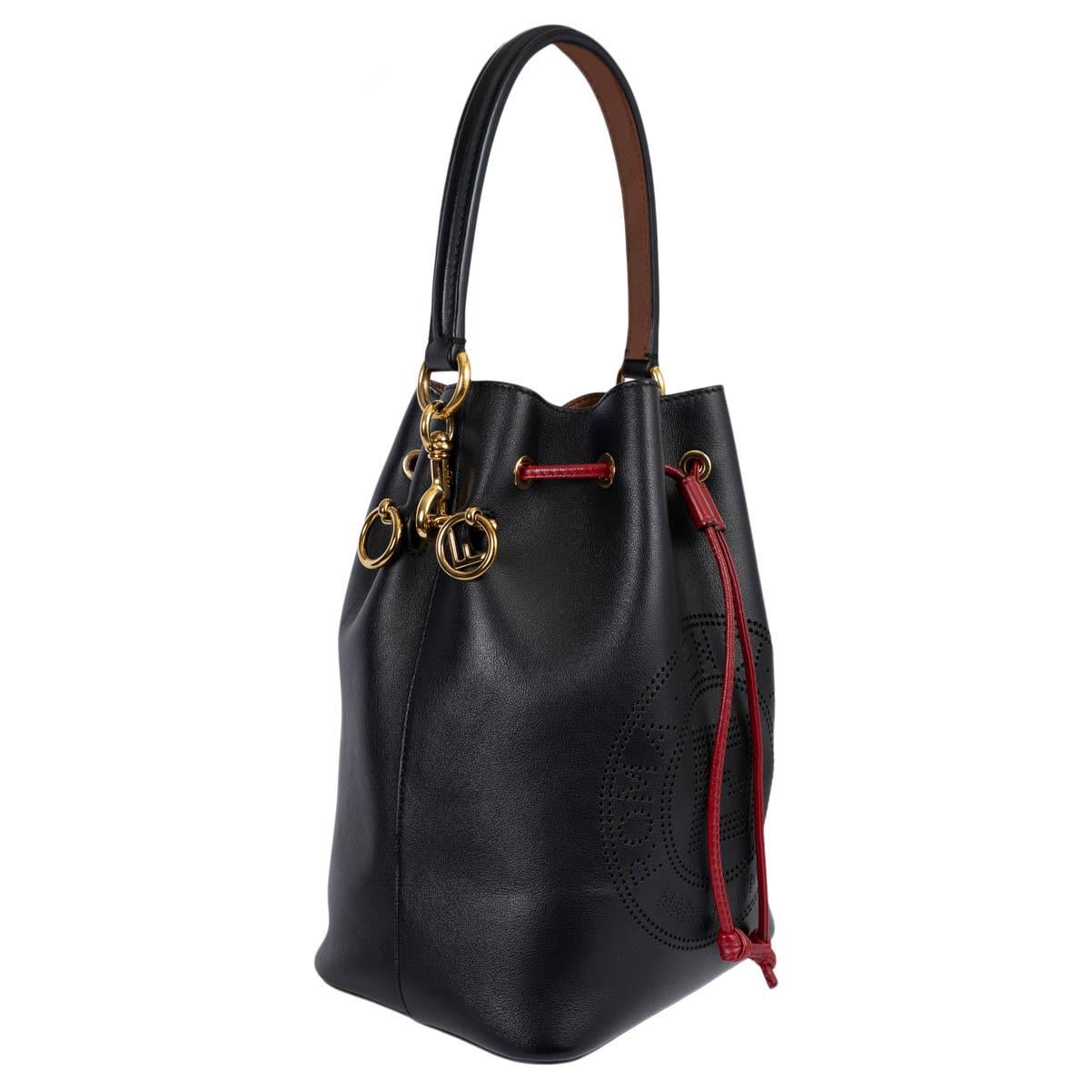 100% authentic Fendi Small Mon Tresor bucket bag in black Vitello Grace smooth calfskin with red drawstring and brown/black shoulder strap. Featuring perforated F is Fendi patch, two detachable shoulder straps, one long and one short, to wear the
