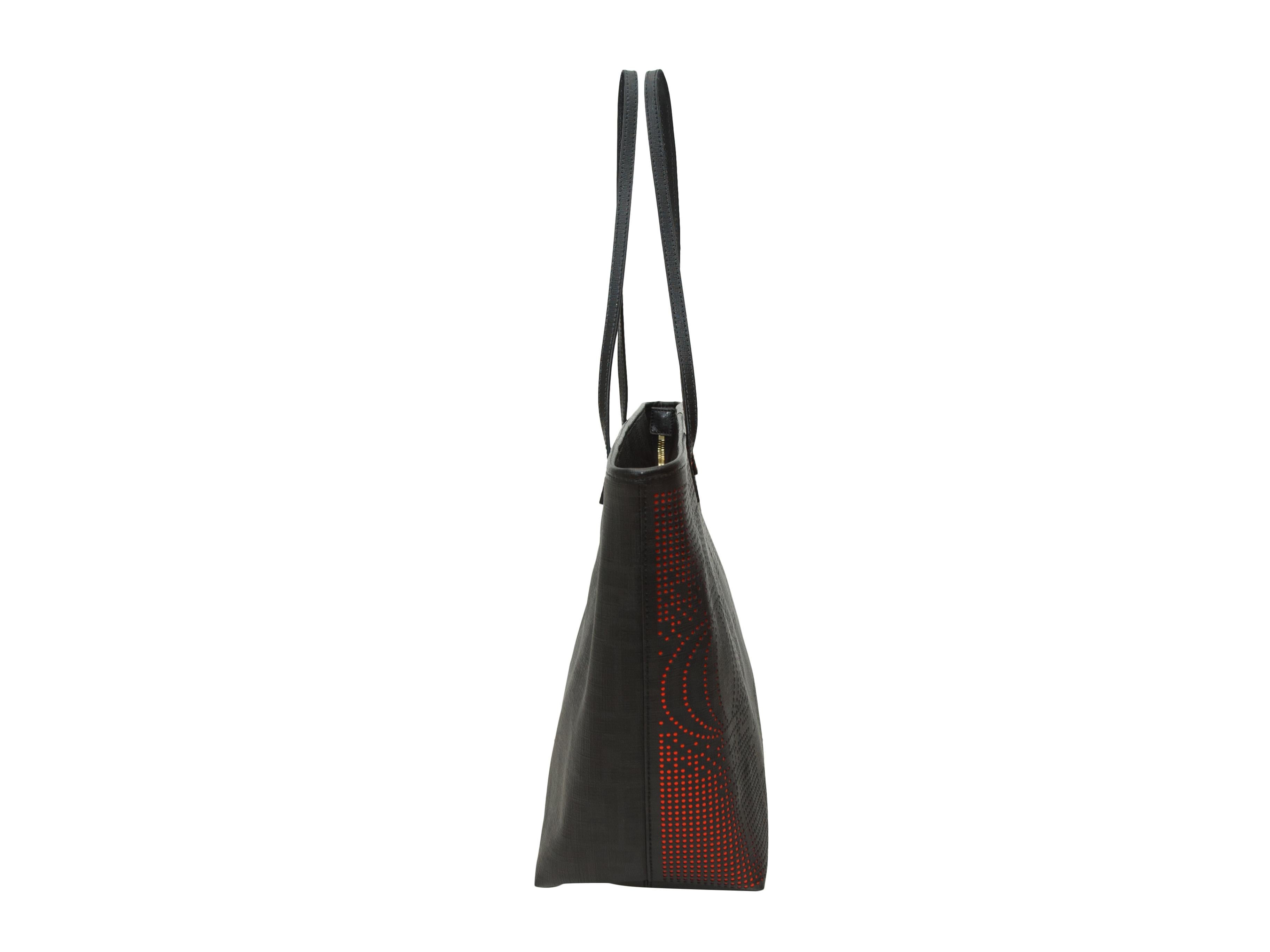 Product details: Black Zucca tote bag by Fendi. Metallic red detailing throughout. Zip closure at top. 17