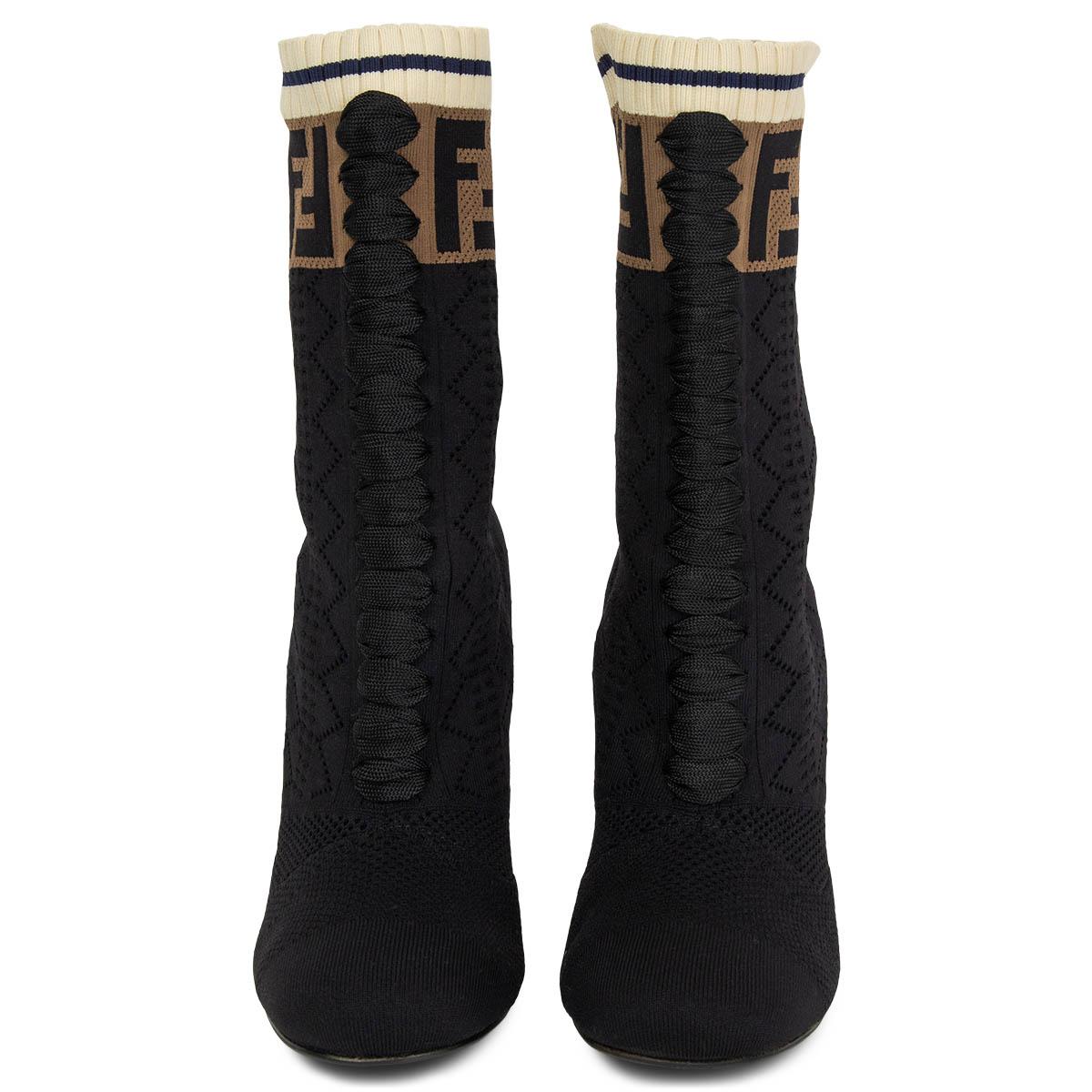 100% authentic Fendi Rockoko Knit Sock Ankle Boots in black stretchy technical fabric with brown Fendi logo knit at the top and decorative lacing detail at front. Booties feature a black and cream curved high heel. Brand new. Come with dust bag.