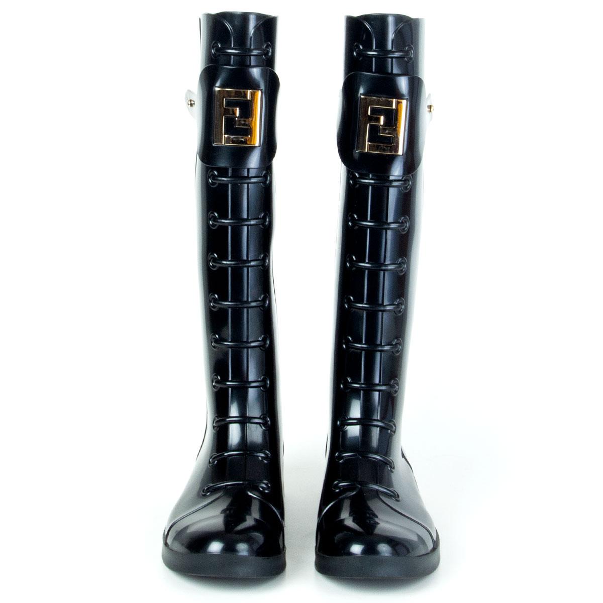 authentic Fendi Berlin knee-high lace-up rubber rain boots in black PVC. Gold-tone metal logo embellishment at front. Have been worn and are in excellent condition. 

Imprinted Size 35
Shoe Size 35
Inside Sole 22cm (8.6in)
Width 7cm (2.7in)
Heel