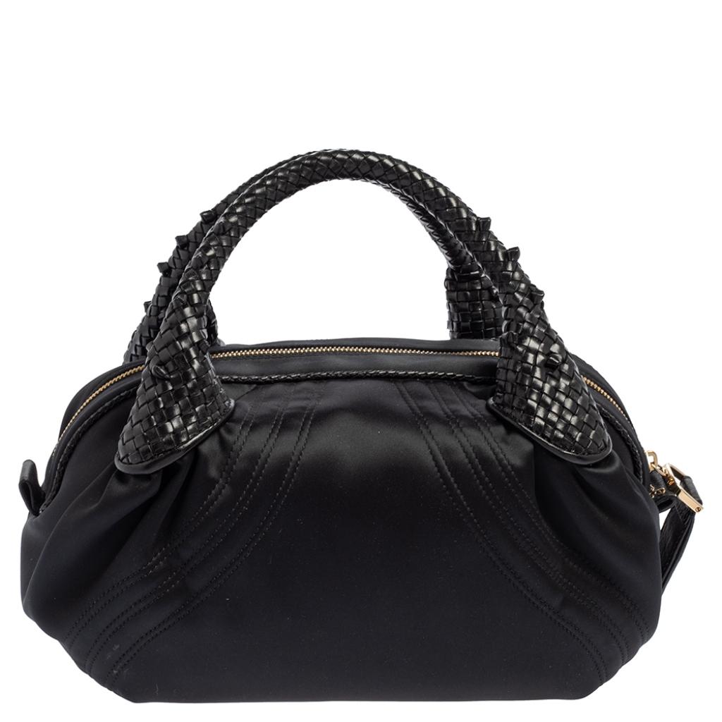 Turn heads each time you wear this unique Baby Spy Bag by Fendi. It is crafted from satin with embossed leather trim and features two top handles, and engraved hardware. This Spy bag lives up to its name with its secret coin pocket. This bag is a