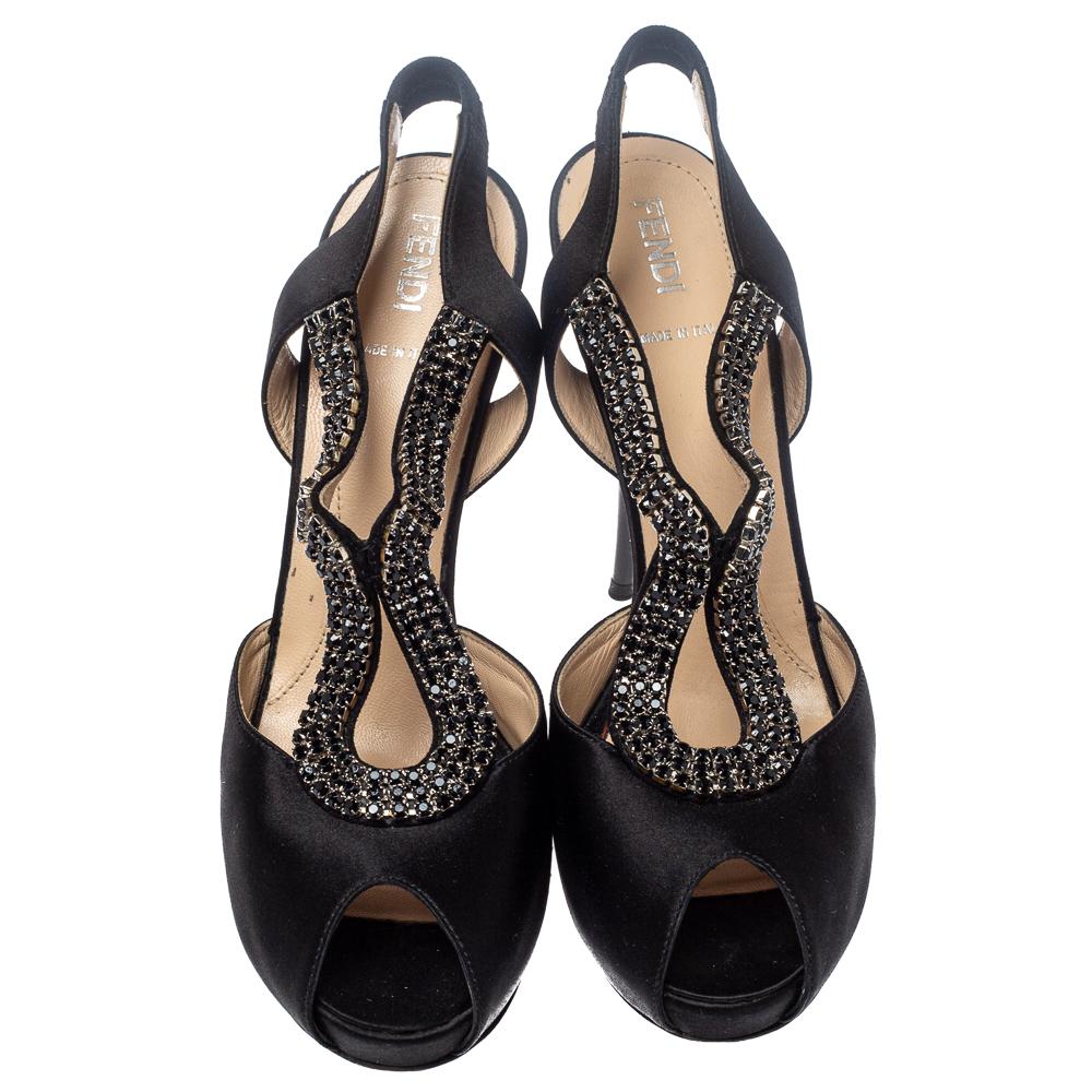 These lovely black sandals by Fendi are stylish and will add a dash of glamour to any outfit. Crafted from luxurious satin, they are styled with peep toes, crystal-embellished vamps, and a slingback design. They are finished with concealed