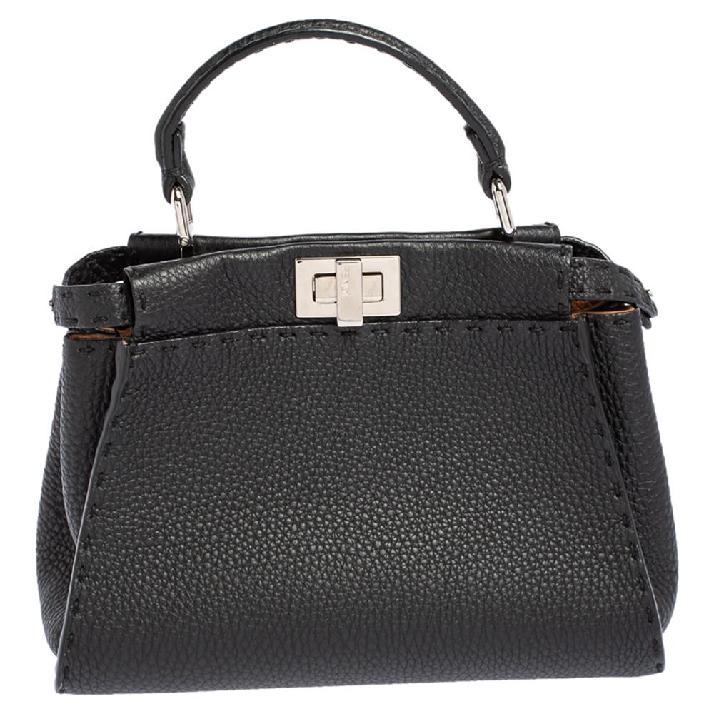 Exquisitely designed and highly coveted, this Peekaboo bag crafted by Fendi continues to sway everyone with its structure, design, and skilled craftsmanship. Made with black Selleria leather and silver-toned implements, this bag lets you explore a