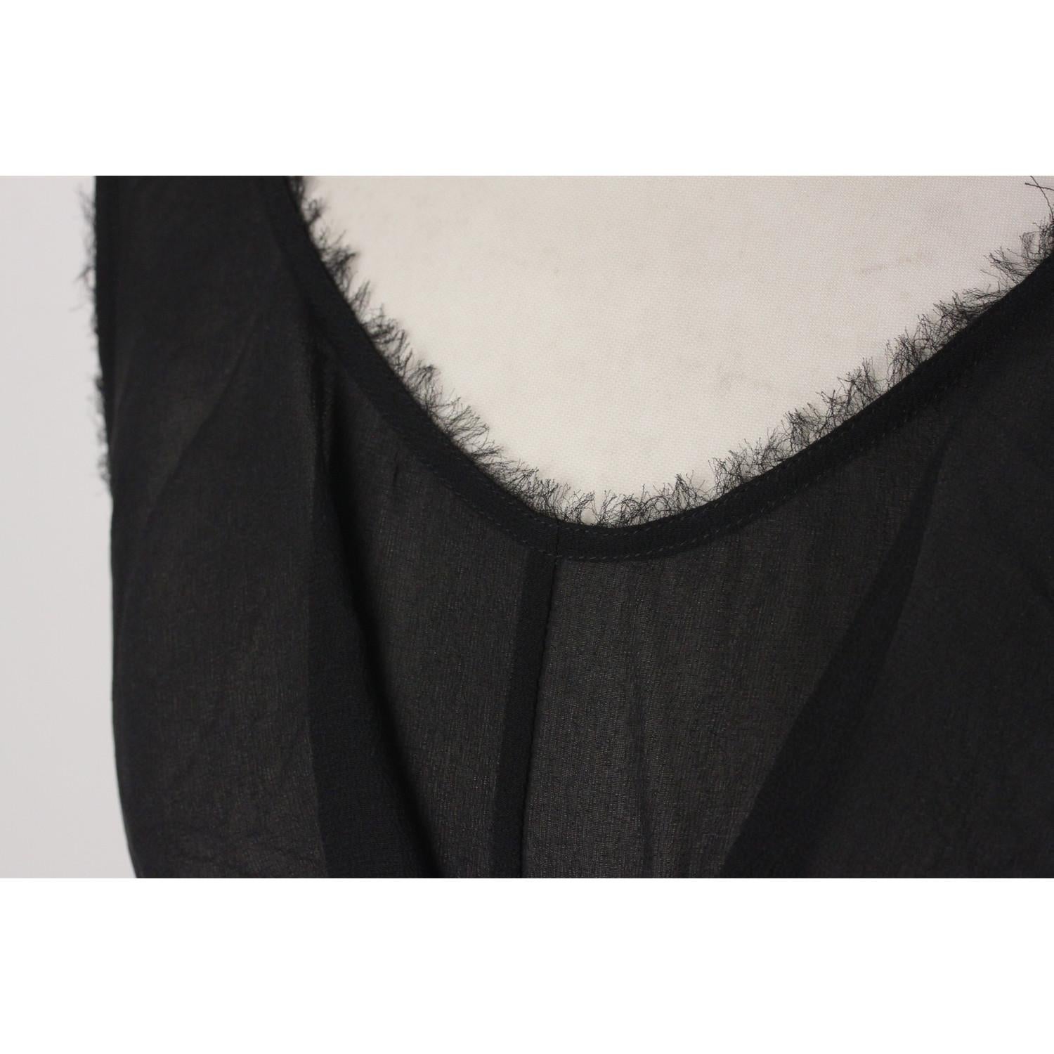 - Fendi Black Silk Sleeveless Dress with Blue Belt
- Sleeveless styling
- Scoop neckline with frills detailing
- Long removable blue belt at the waist
- Frayed edges
- Color block design
- Composition: 100% silk
- Zip closure to the back
- Size: 44