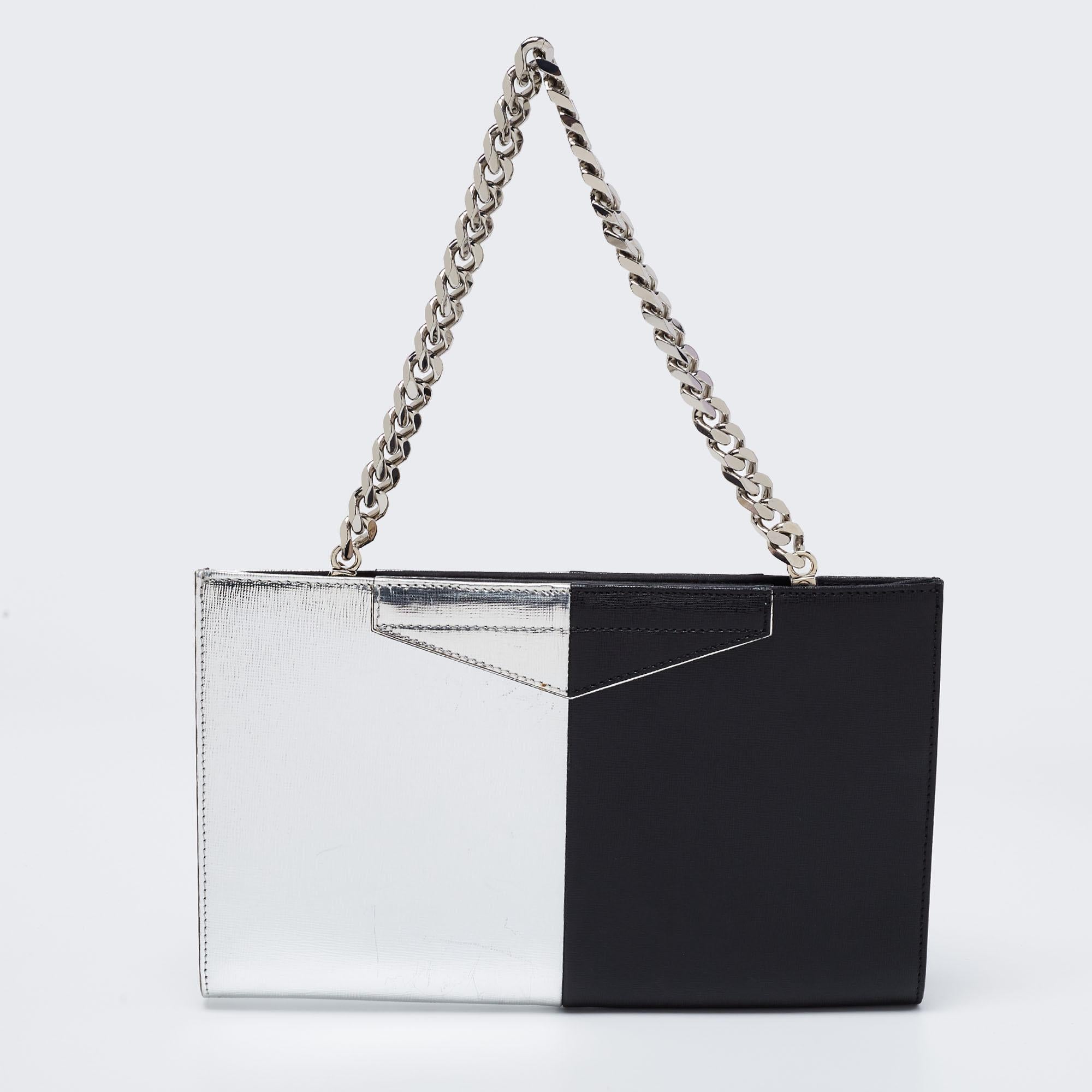 This clutch from Fendi has an appealing design, perfect to complement an evening dress or a day ensemble. Crafted from black & silver leather, the creation has a rectangular shape with a chain on top.

Includes: Original Dustbag, Info Booklet
