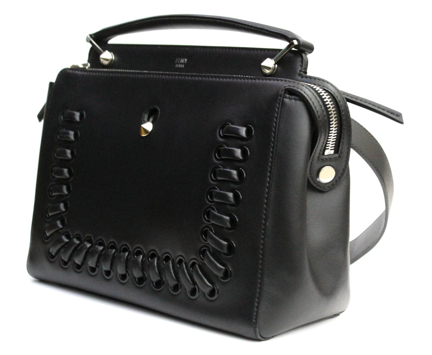 The Dotcom bag is one of Fendi's newest creations. This stunning bag is crafted out of smooth calfskin leather and has a modern structured shape. This chic bag has two compartments, divided by a stiff partition. Both sections have a zip closure and