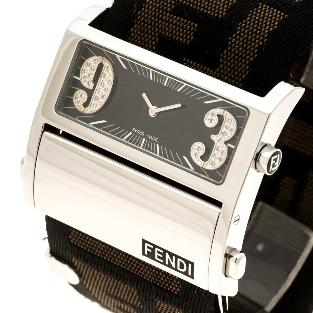 Style and practicality come together in this Fendi Zip Code Women's Wristwatch. It has a black dial, two oversized diamond studded numerals, hour markers and hour indicators. The Zucca fabric strap fixes on the wrist with a deployment clasp. This