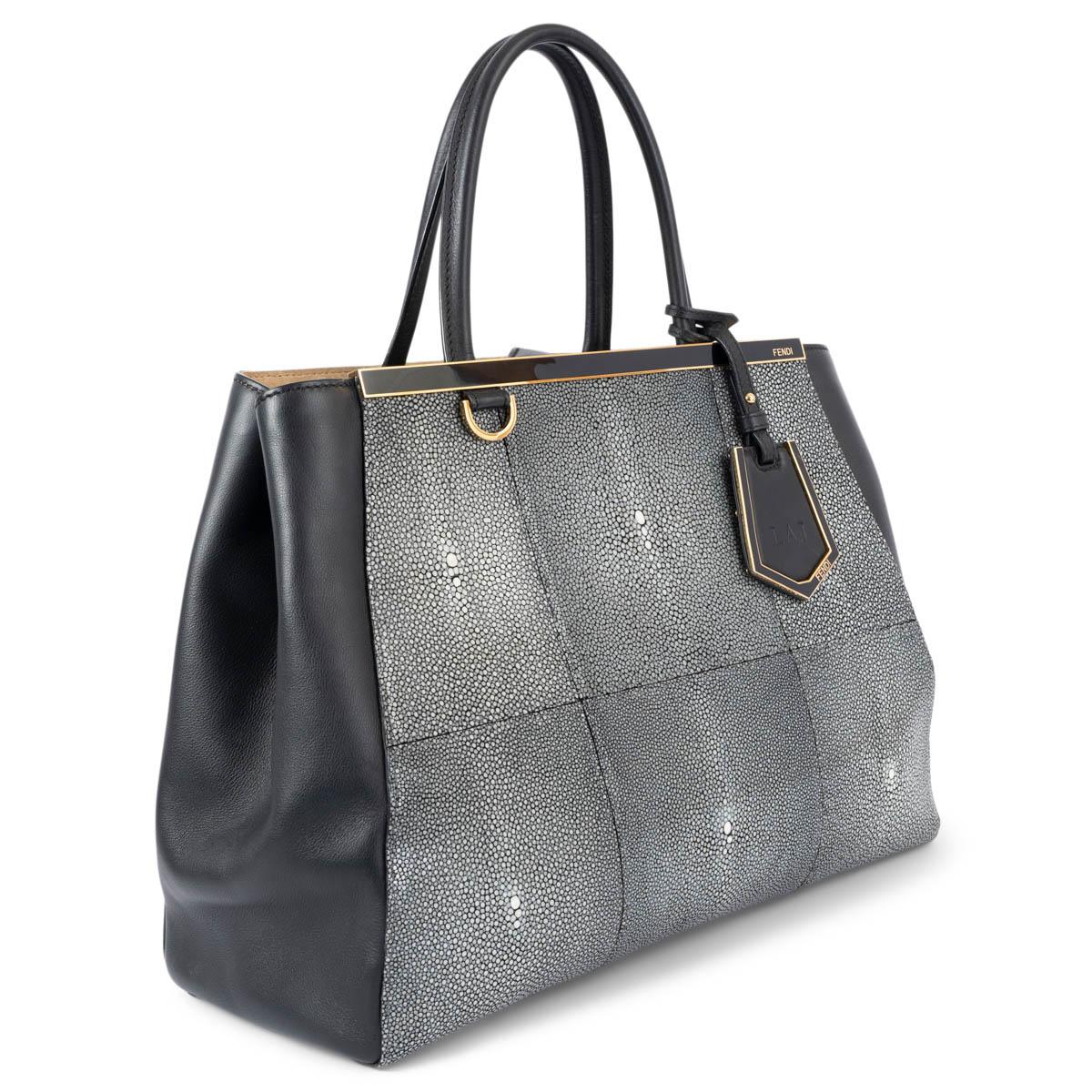 100% authentic Fendi Medium 2jours bag in grey and white stingray and smooth black leather. The design features gold-tone hardware and opens with a push-butoon to a beige suede and linen lined interior with one large zipped compartment in the middle
