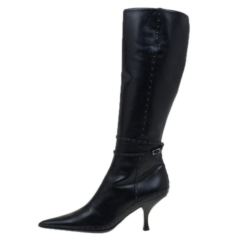 This pair of Fendi boots has a knee-high style. The boots have stud detail piping and ankle straps. Crafted from black leather they feature a pointed toe and kitten heel. Comfortable in style this pair is a must-have in your shoe